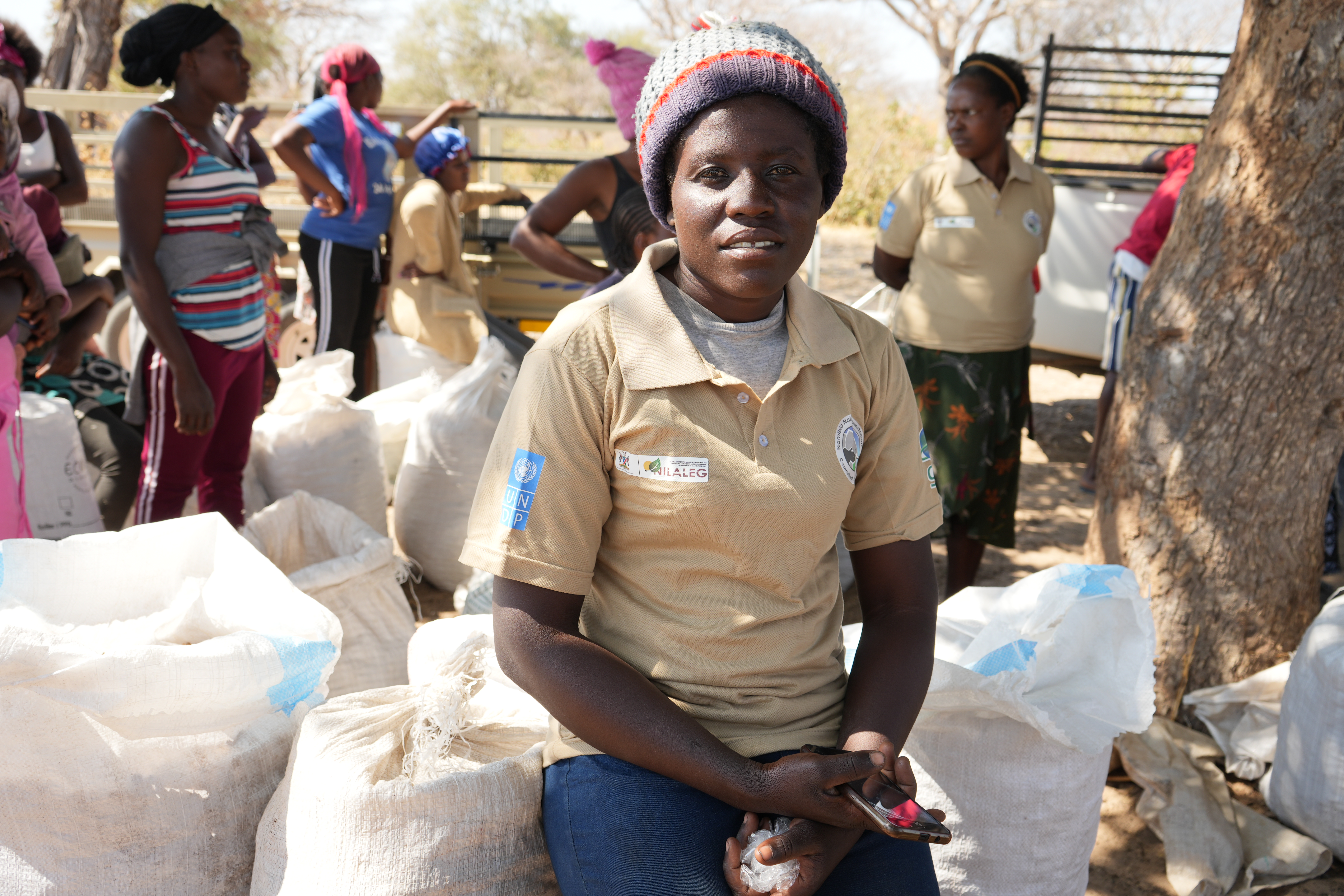 Tresia after submitting her harvest to the buyer, waiting for her income. Photo: UNDP Namibia/Frieda Lukas