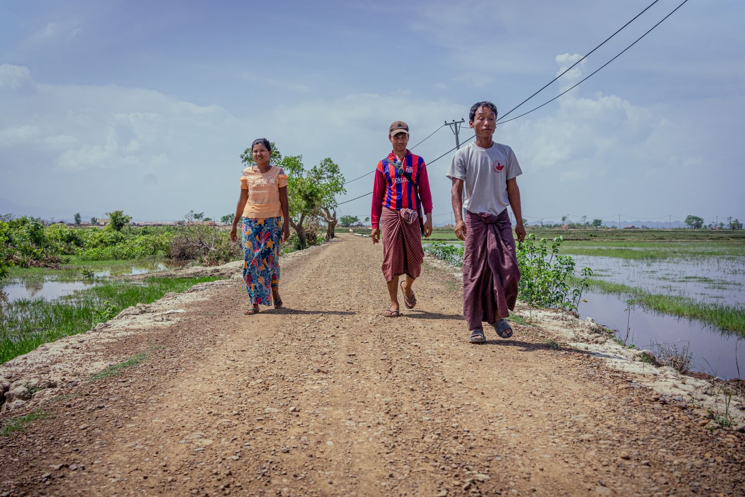 Community members walk along a road UNDP helped construct in Rakhine State's Kyauktaw Township