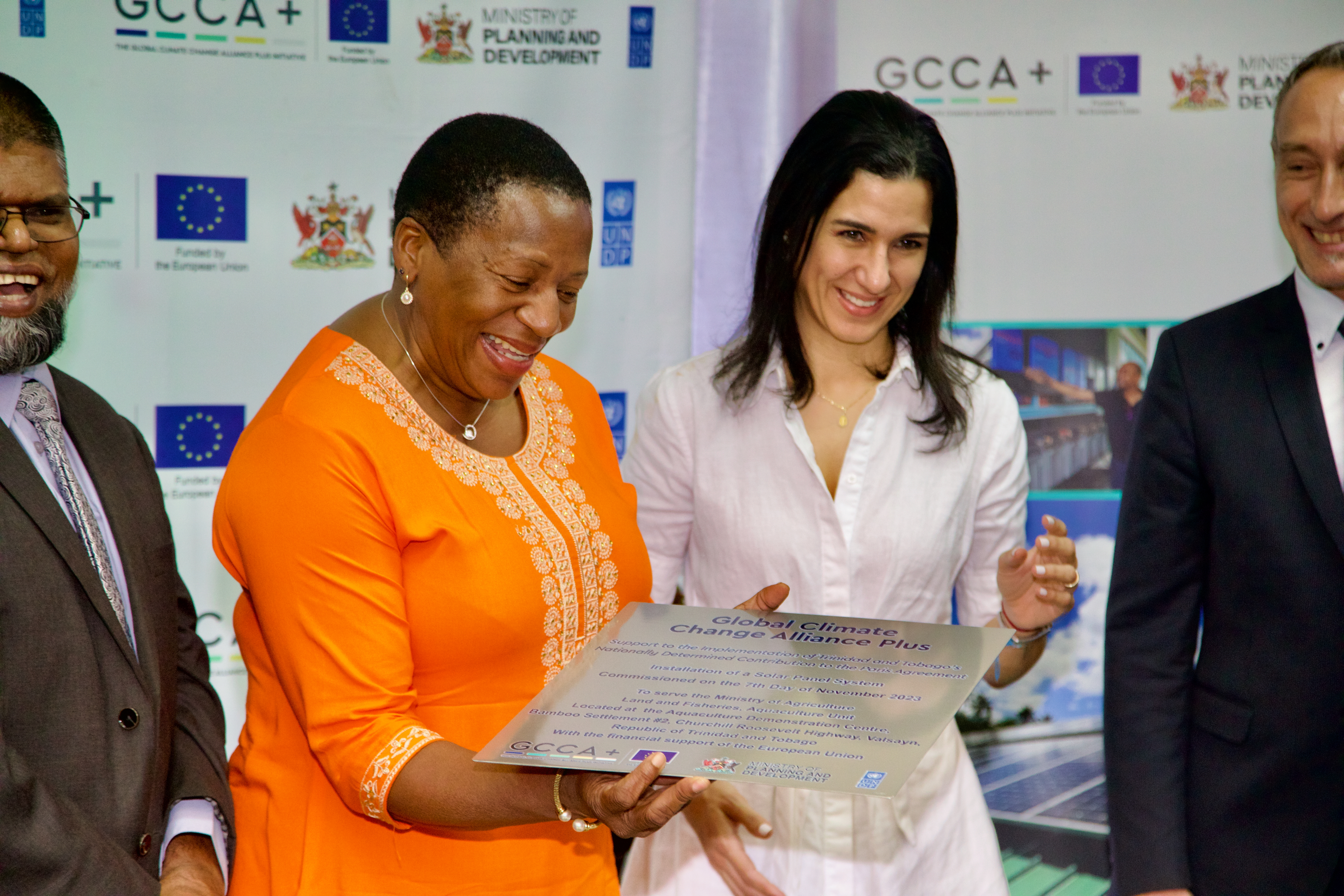  The Honourable Penelope Beckles-Robinson and Michelle Muschett share a light moment during the Solar PV Installation Handover