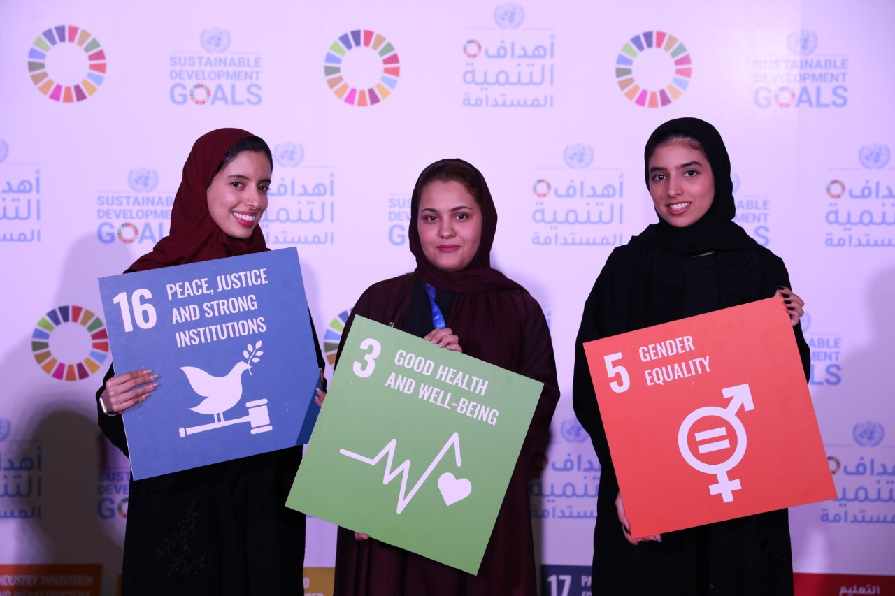 Woman in hijabs with SDG signs 