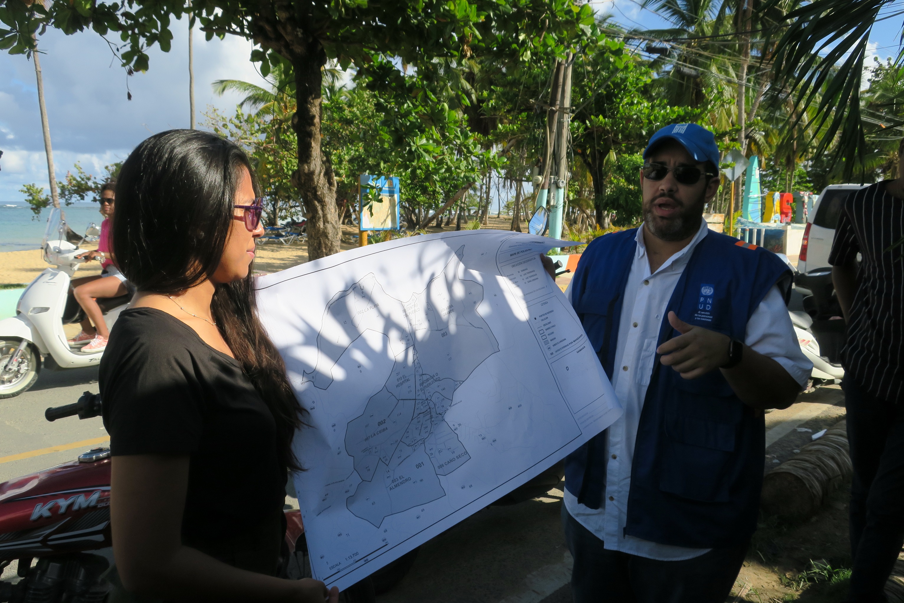 A woman and man look at map of affected area