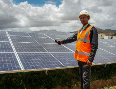 man in front of solar panels
