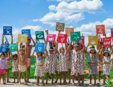 children holding SDG signs