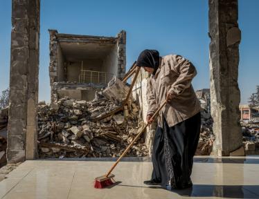 woman cleaning debris