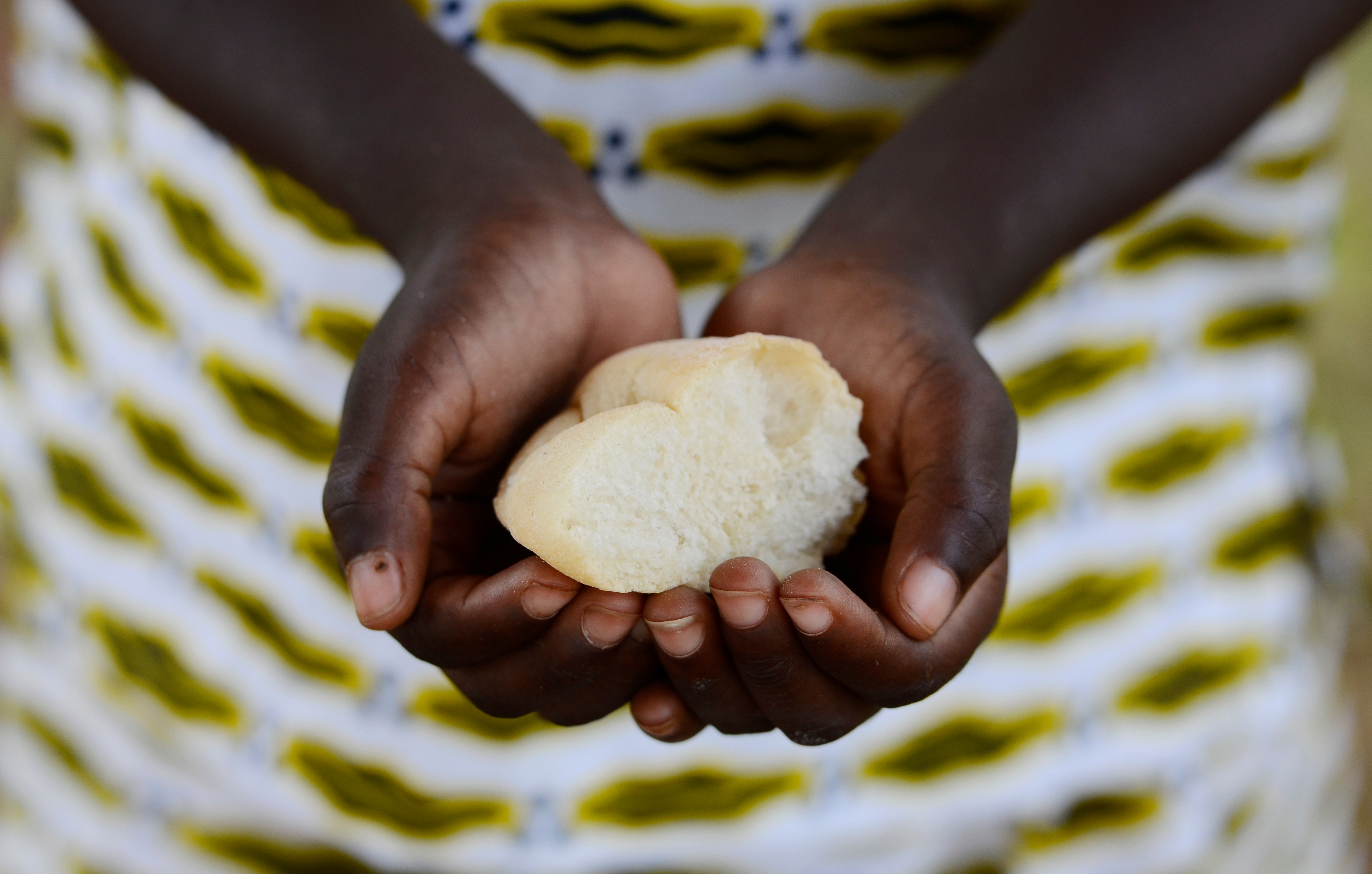 Hands of African woman holding wheat-based food ball
