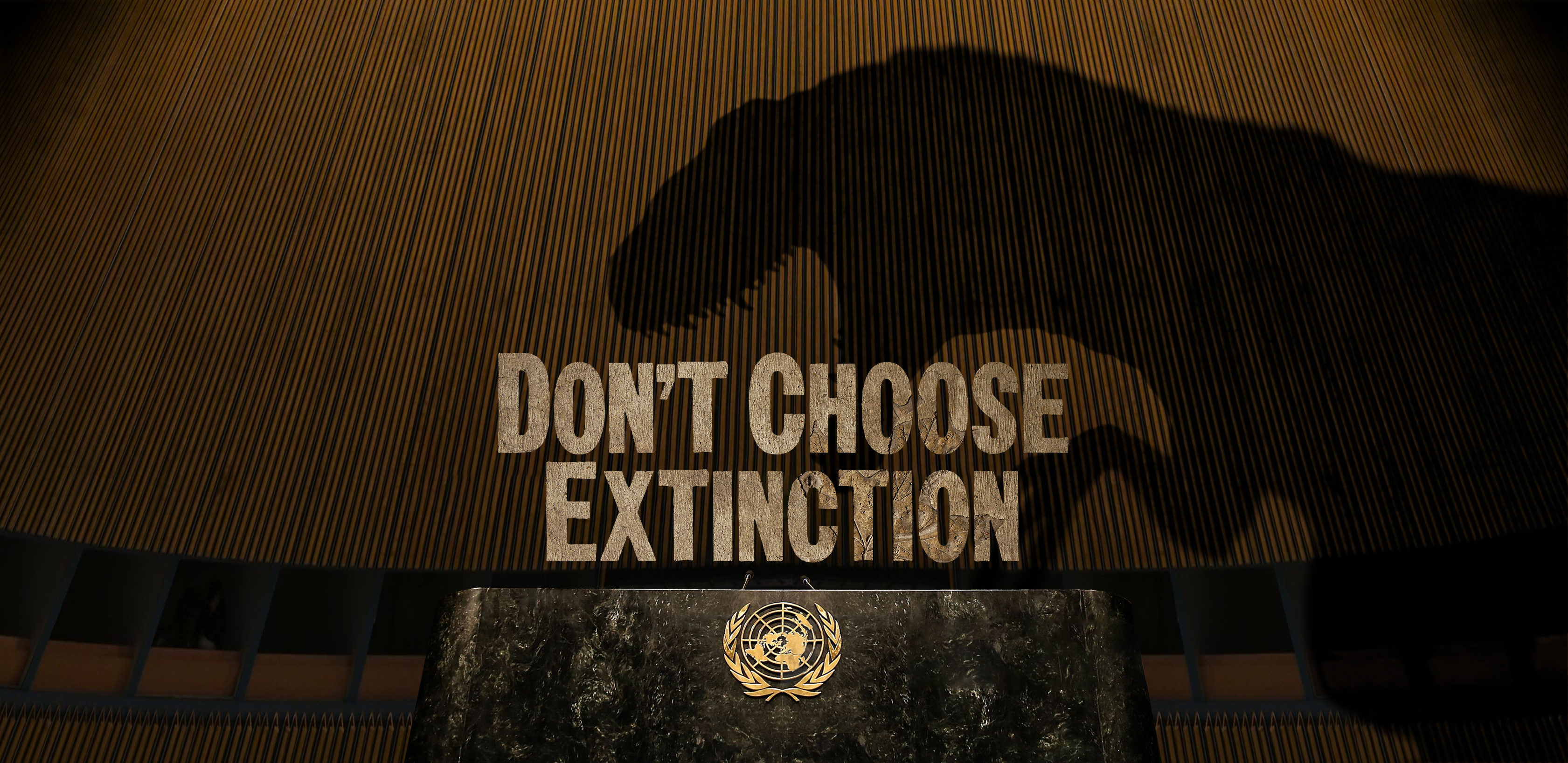 En skygge af en dinosaur ses bag teksten Don't Choose Extinction