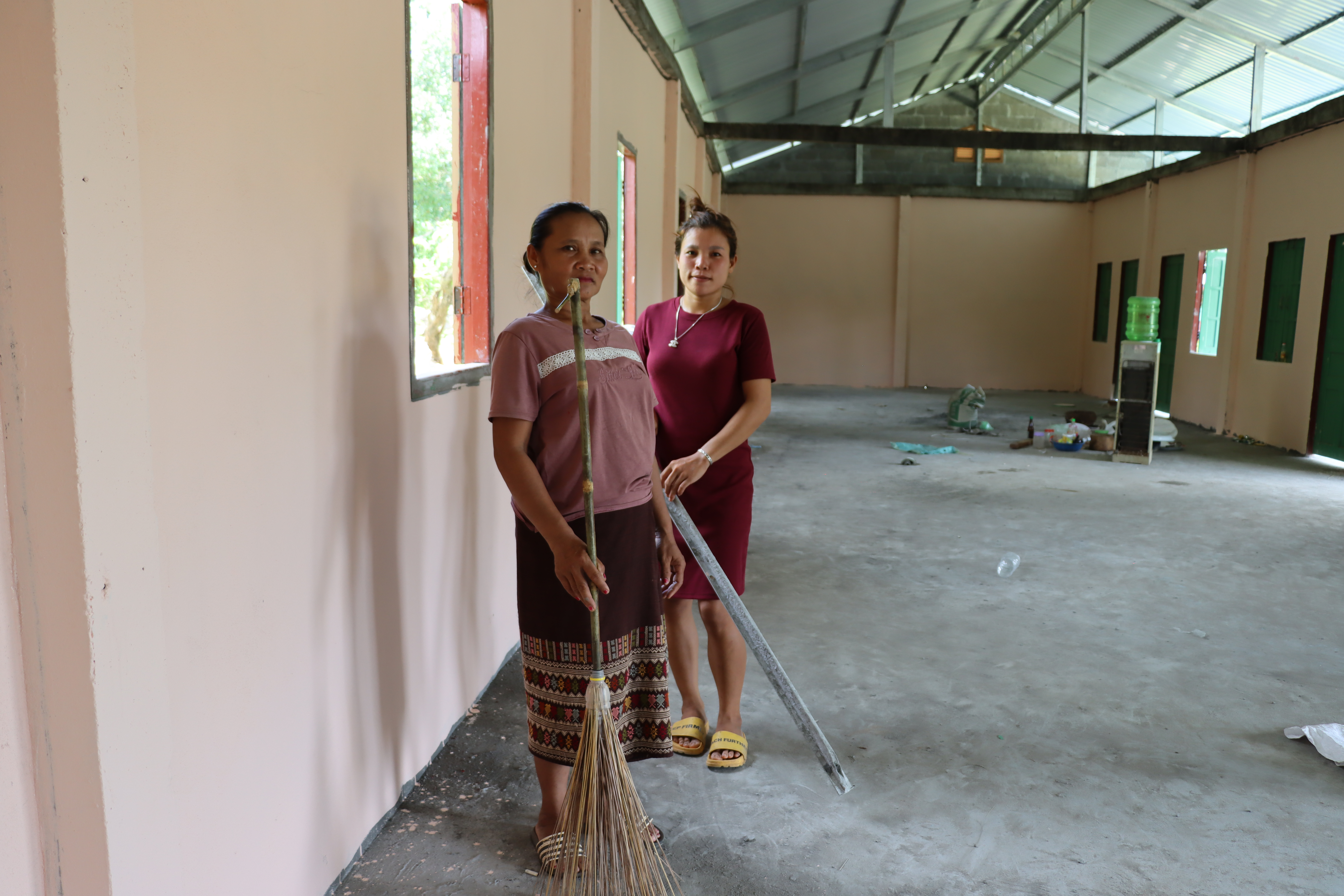 2 women about to clean the inside of an evacuation center