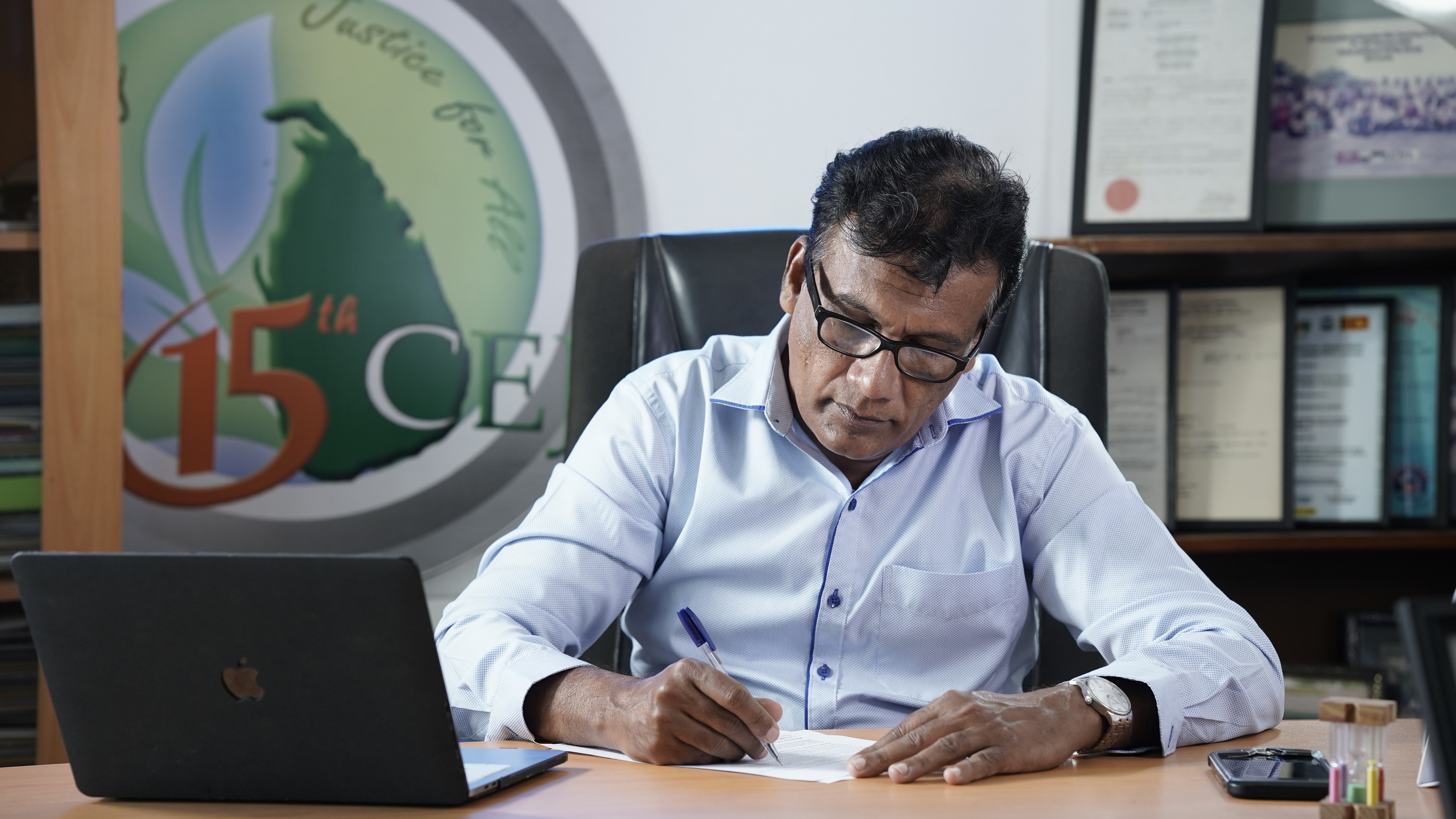 Mr Hemantha Withanage at his desk
