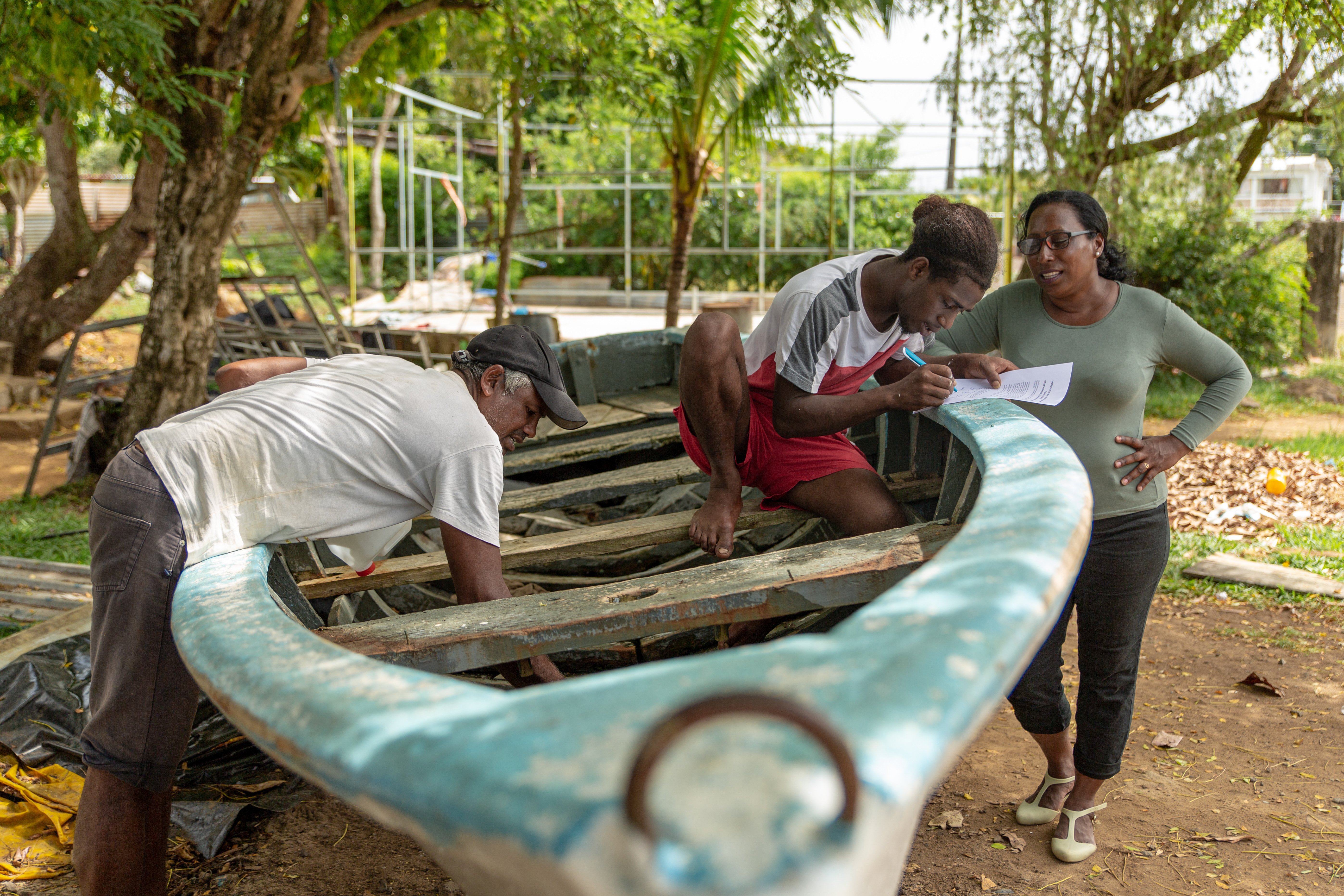 Fishers of the South-East coast repairing a pirogue