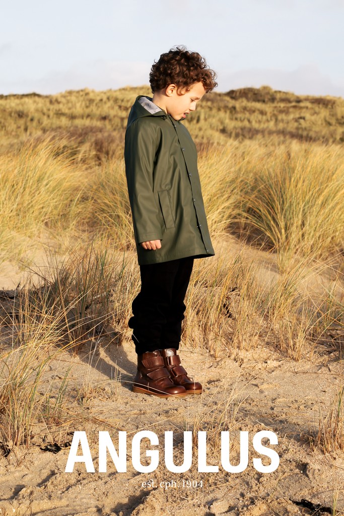 little boy standing on beach