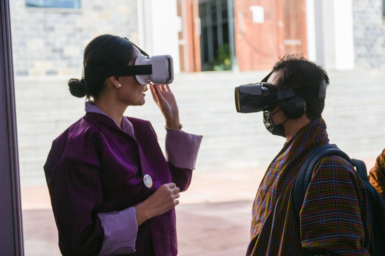 A woman and a man wearing virtual reality headsets