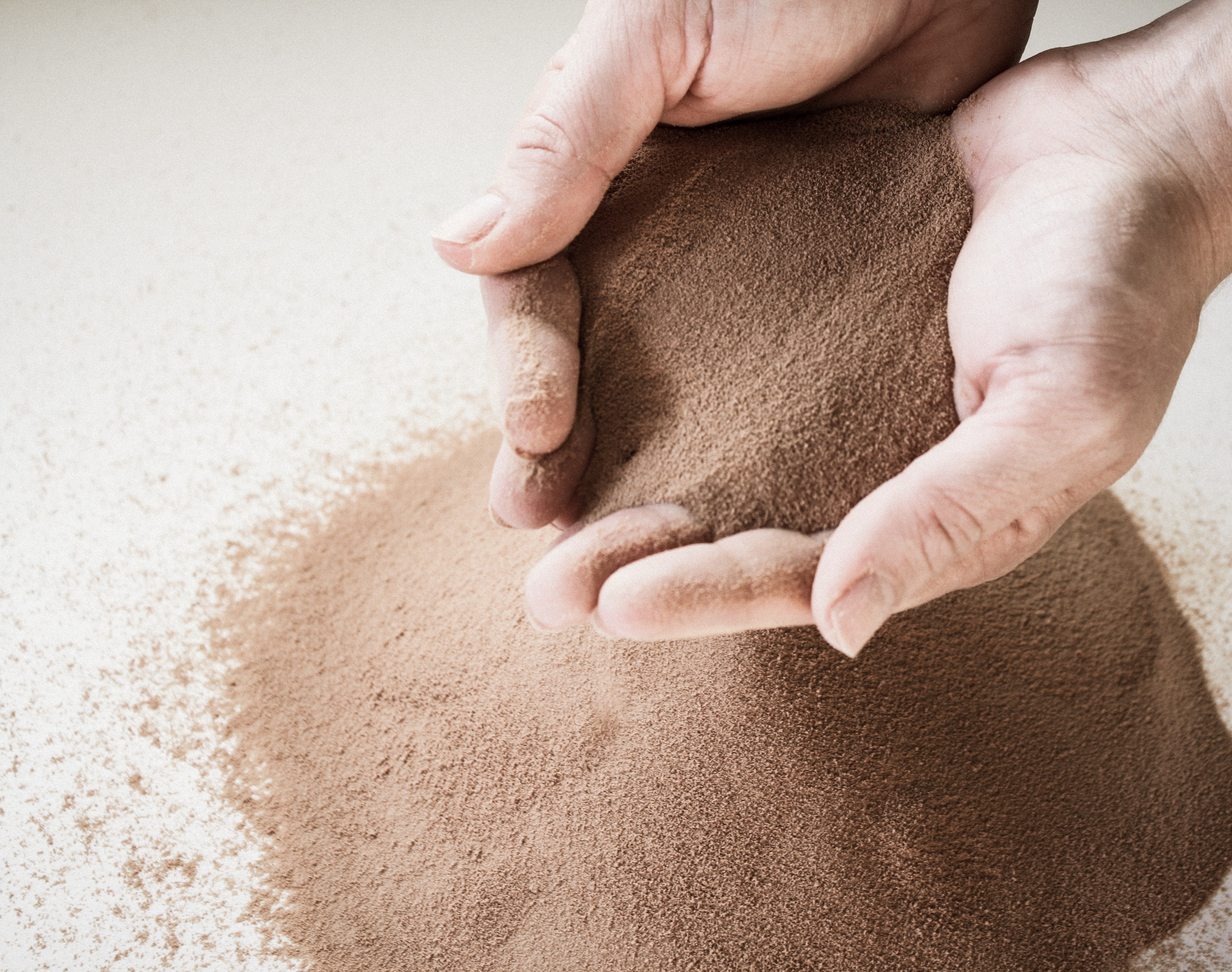 hands in brown powder