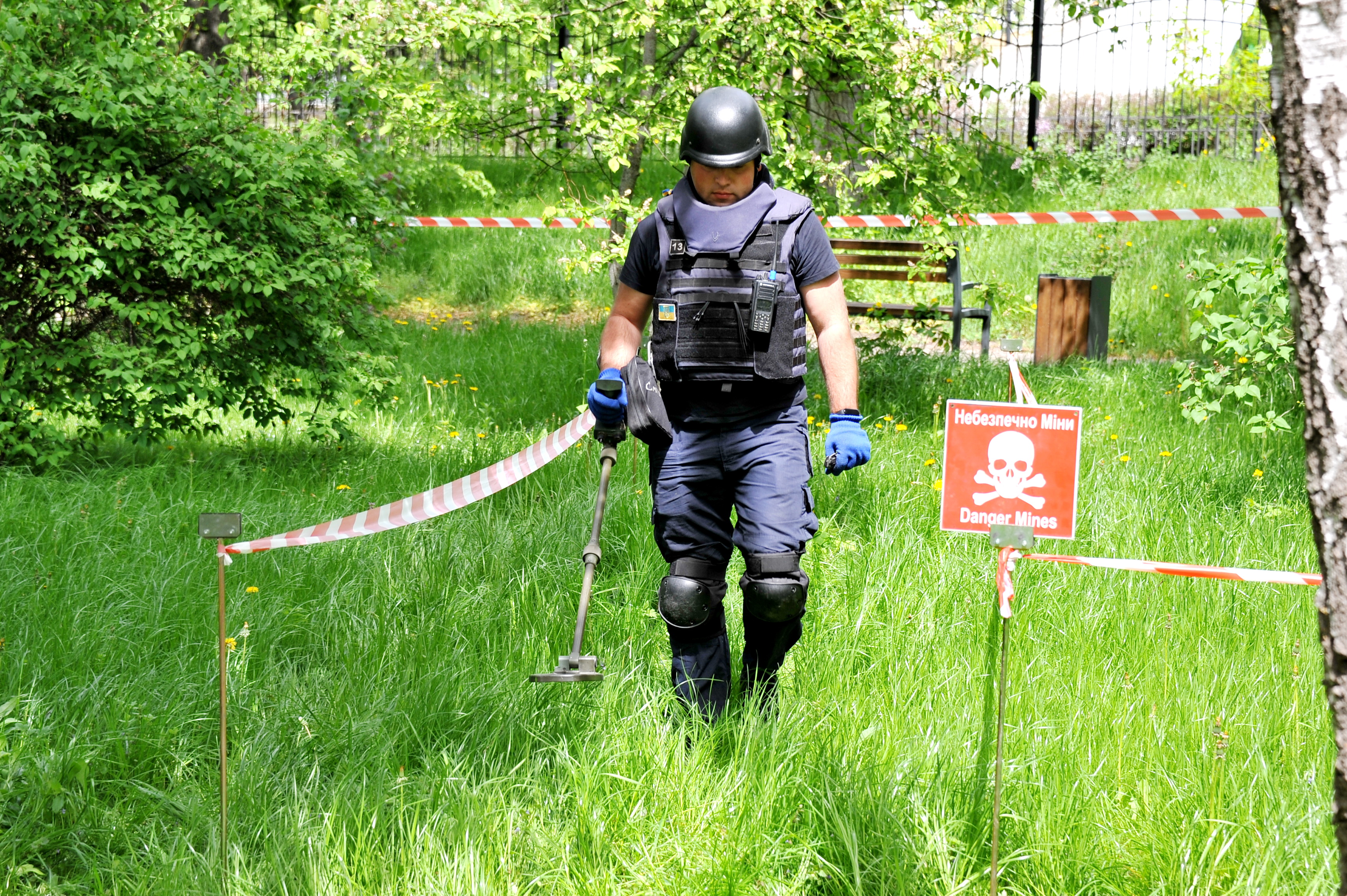 An employee of the State Emergency Service of Ukraine sweeps an area of ground for unexploded ordnance and landmines. Photo credit – Oleksandr Simonenko / UNDP Ukraine.