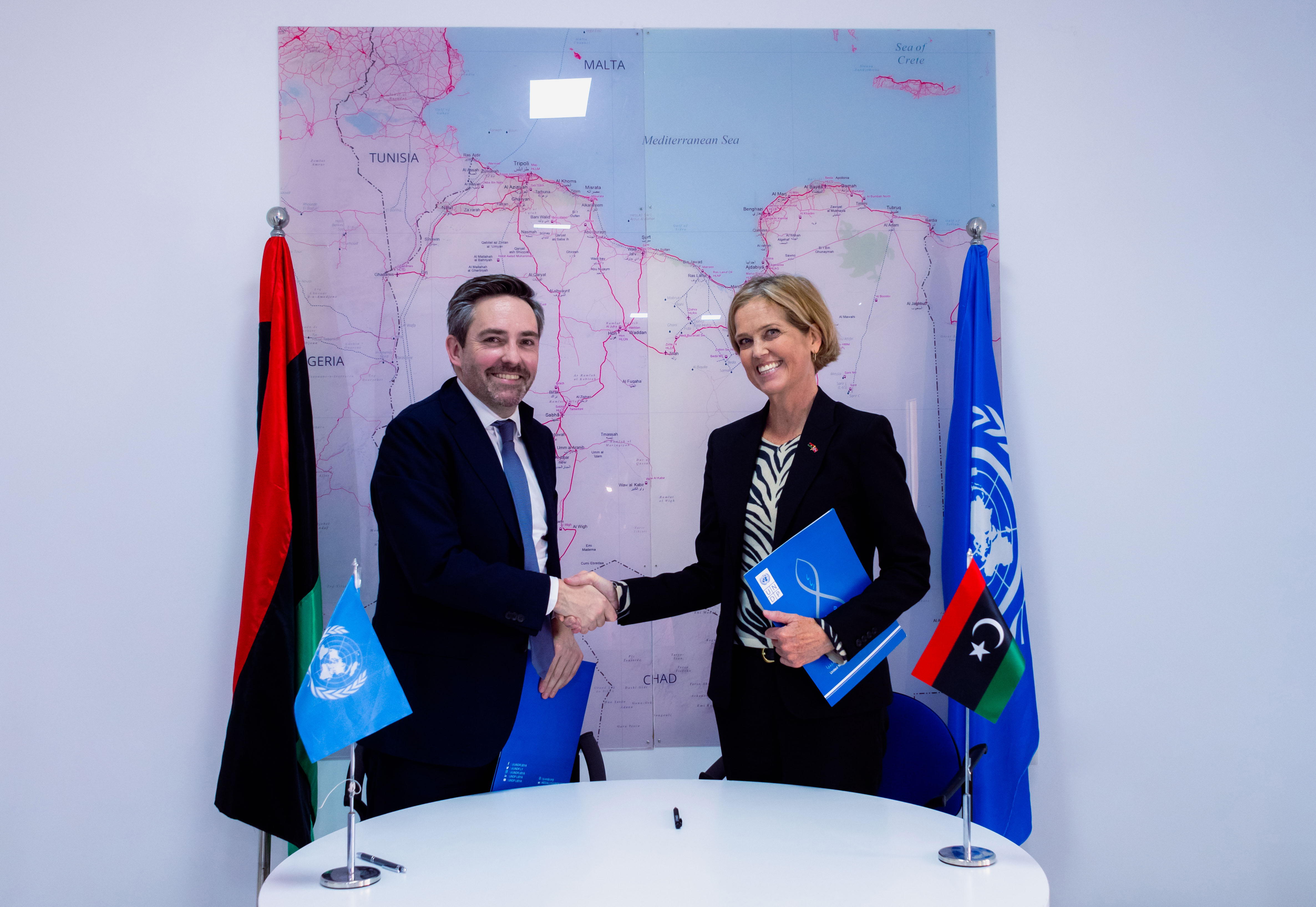 Resident Representative for Libya Marc-Andre Franche shaking hands with Norway Ambassador to Libya H.E Hilde Klemetsdal during signing ceremony