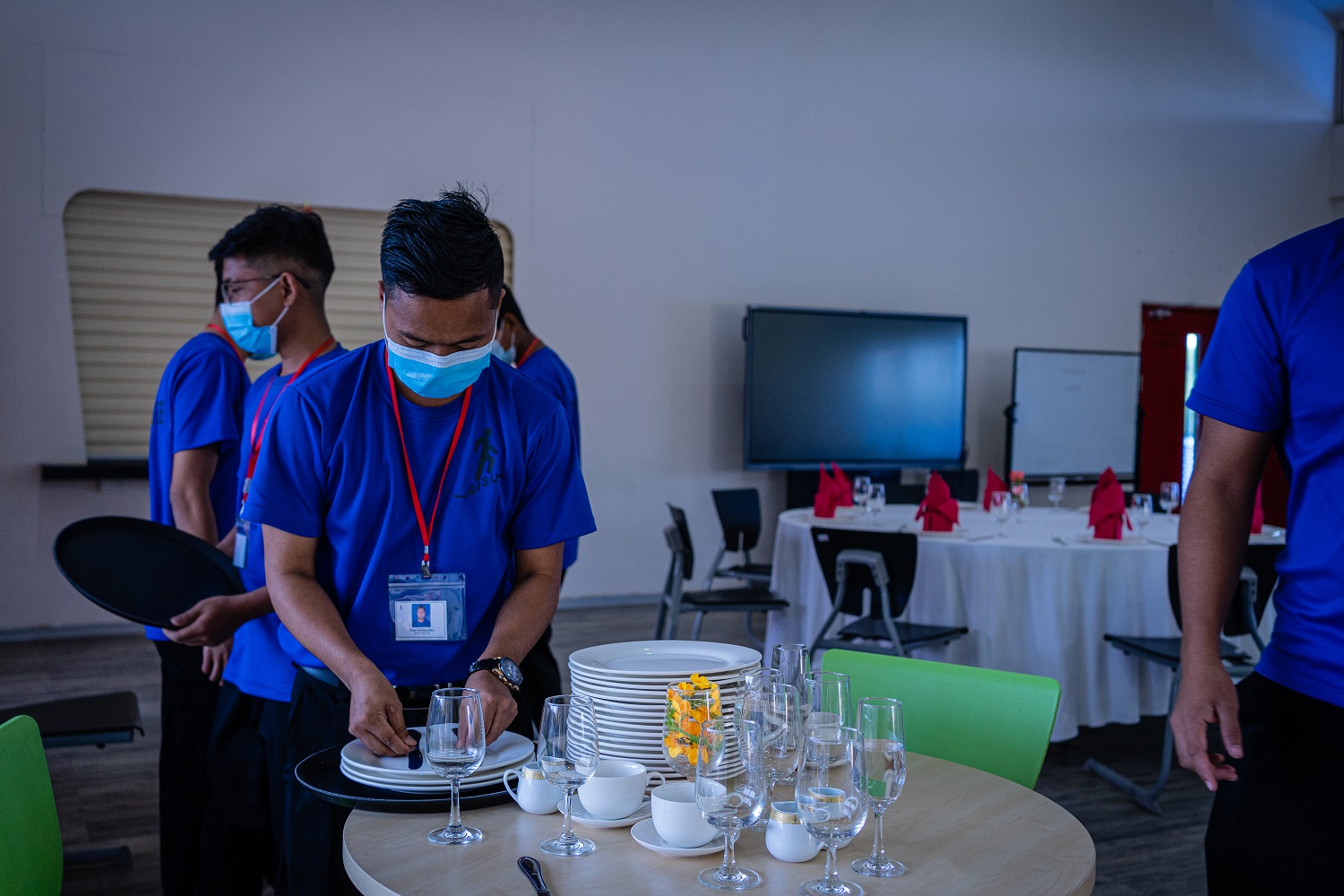 Yan Naing Tun, 24-year-old current SISU student, lays a table as part of his hospitality training