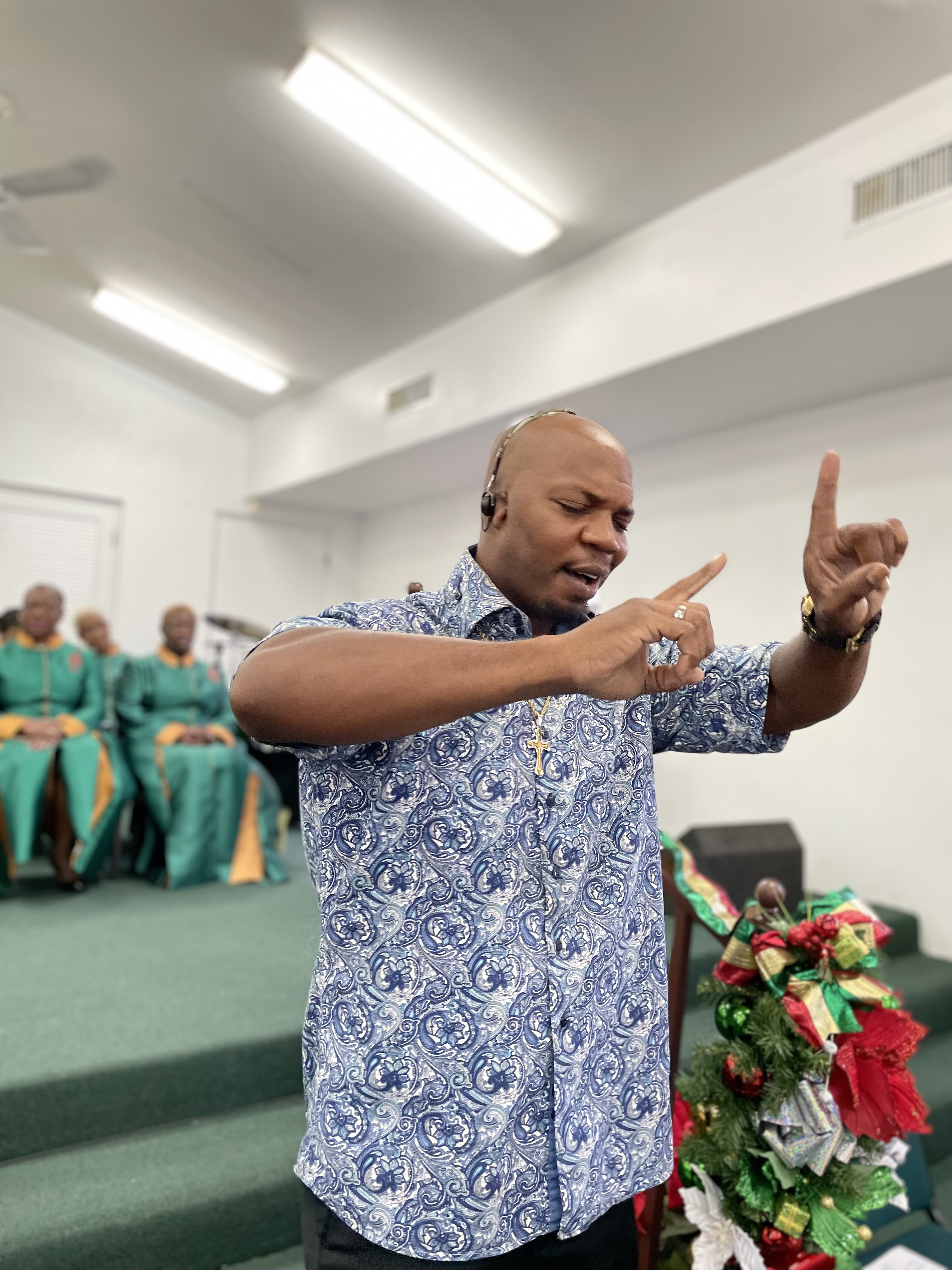 Man worshipping at church in Bahamas. Pic for Debt Management story