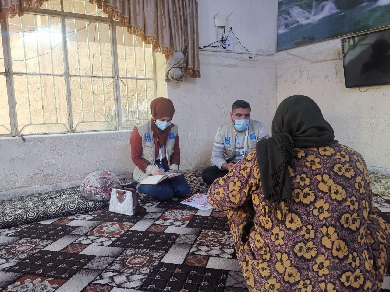 UNDP mental health workers interviewing a woman in Iraq.