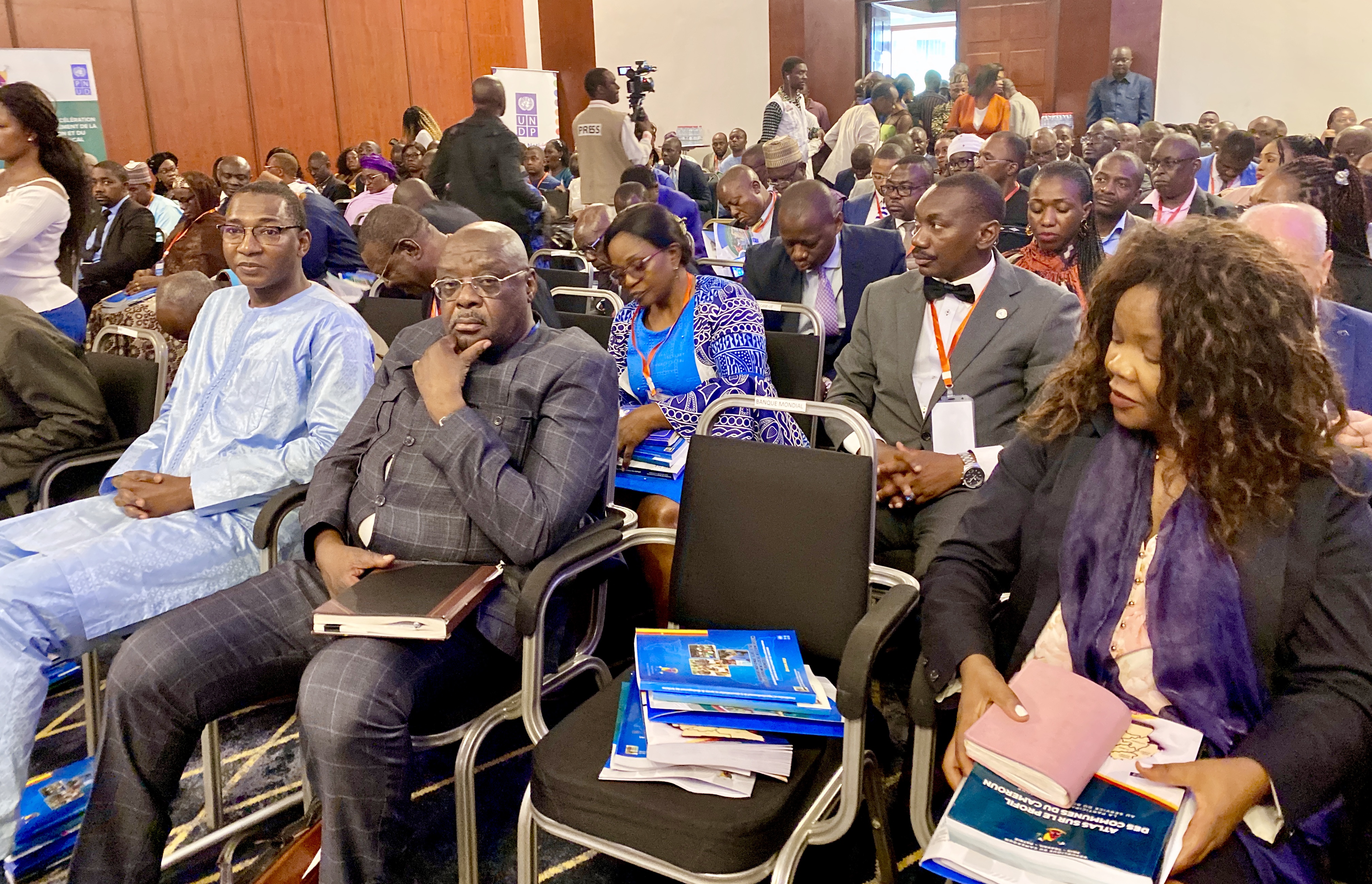 UNDP DRR, Mr. Alasane Ba, UNDP Senior Economist, Ms. Ginette Mondongou Camara, and stakeholders with copies of the Strategic Studies. 