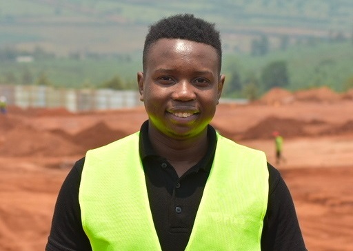 Tafara in green vest at a job site