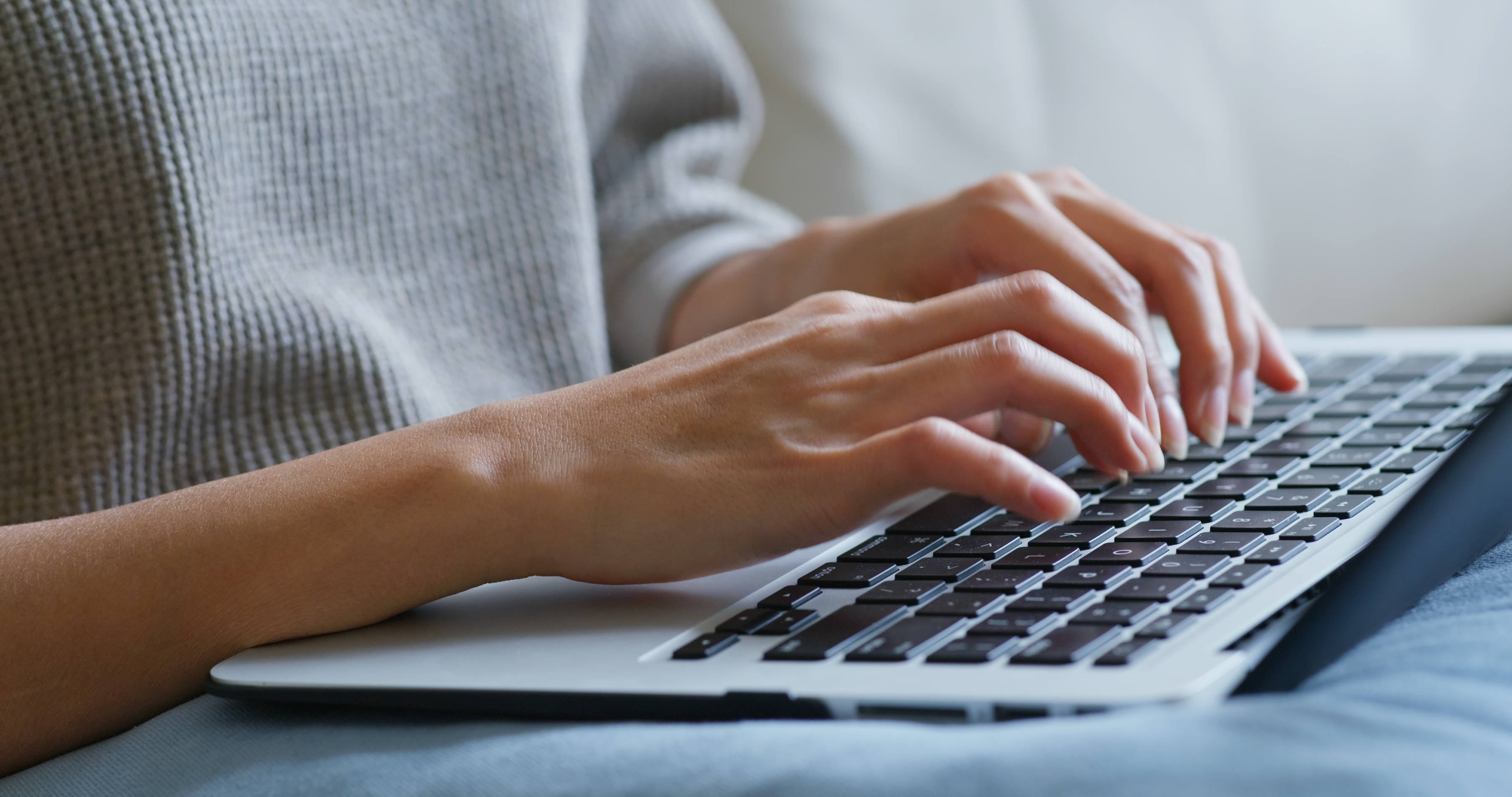 person typing on laptop keyboard 