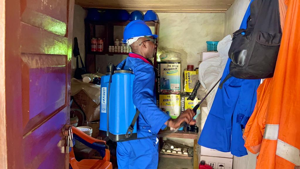 Photo showing Mustapha Mambu in full gear and ready to provide pesticide services in his district