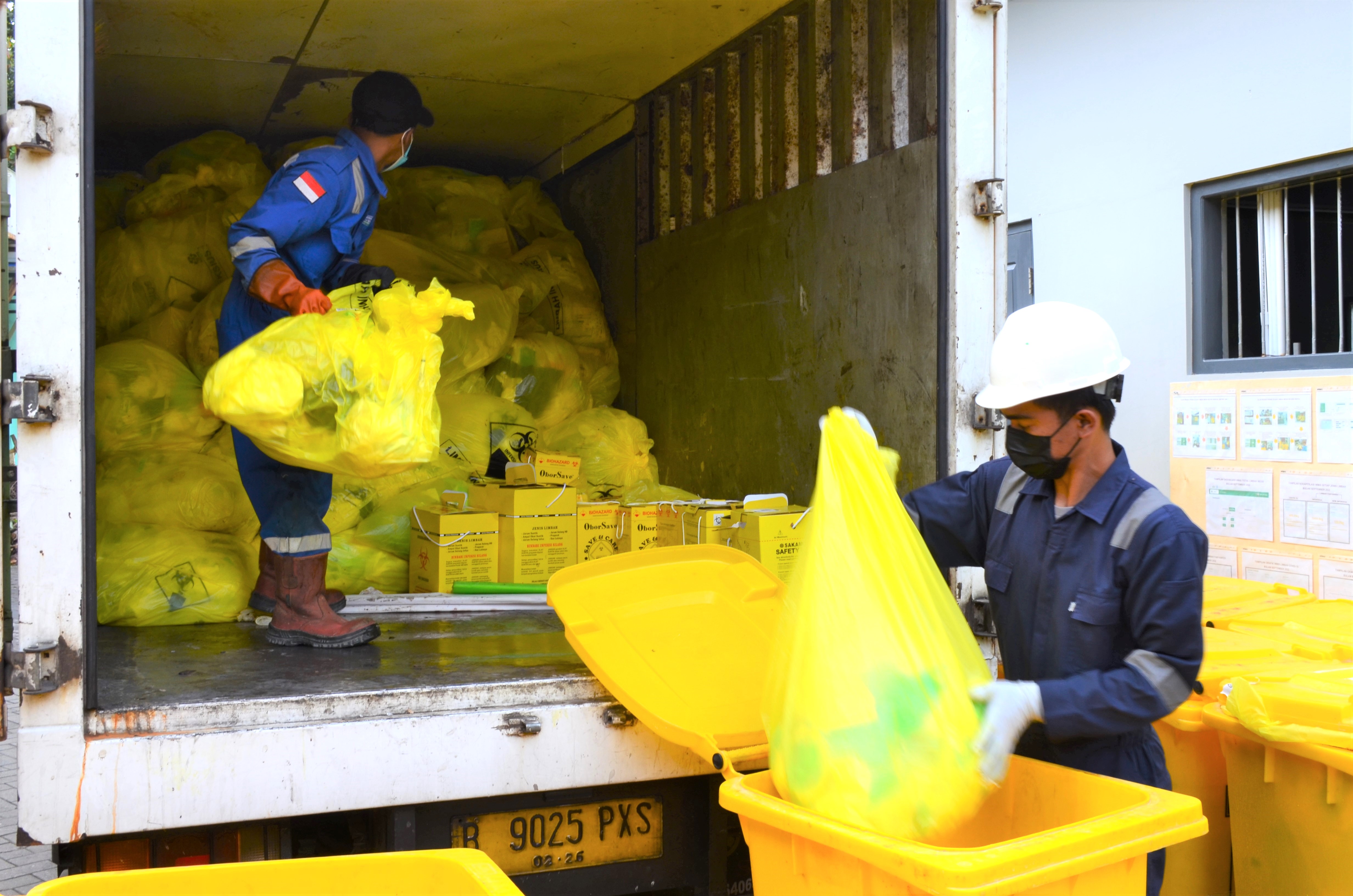 Workers handling health care waste