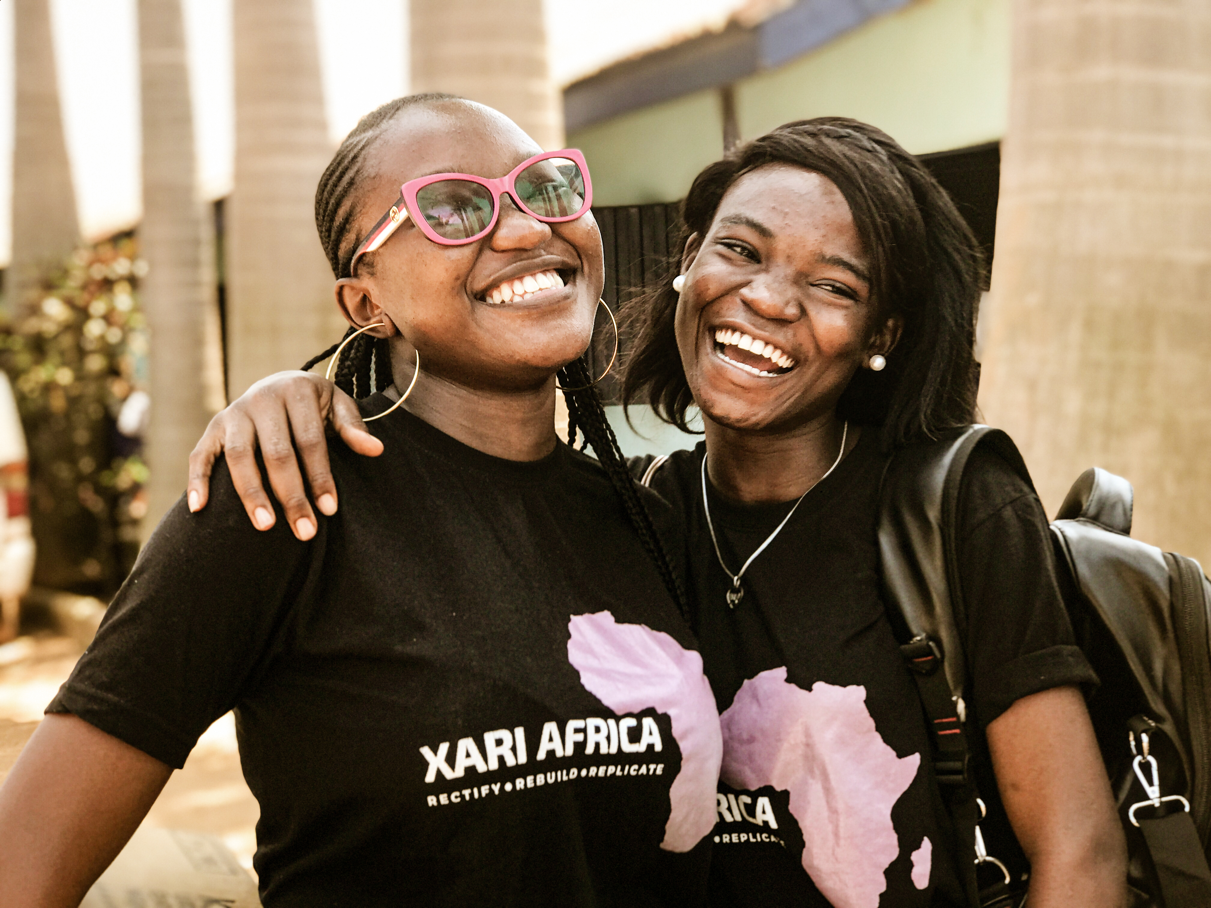 Two women in black tee shirts laughing