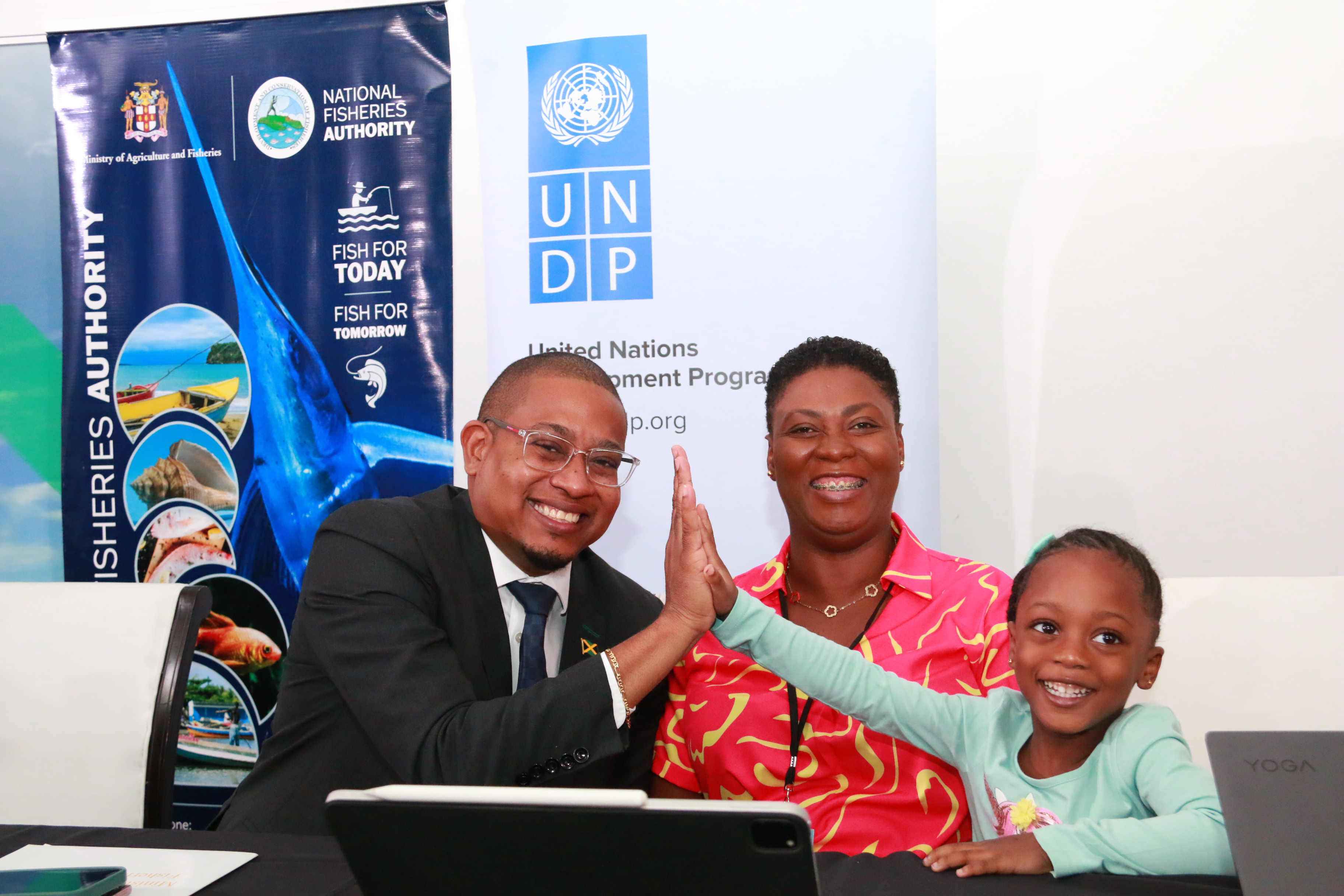 Minister of Agriculture and Fisheries spends a moment with UNDP OIC and her daughter