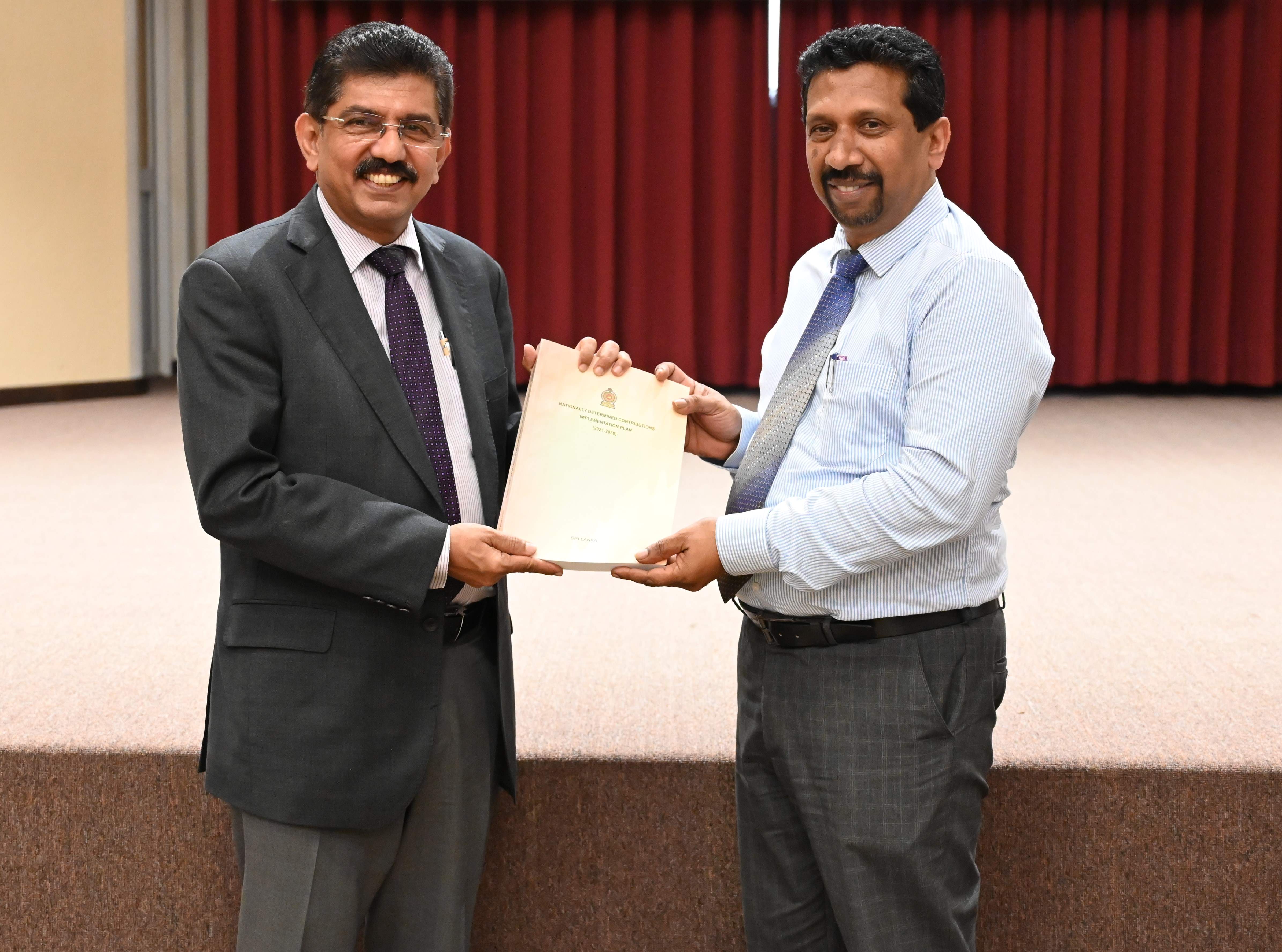 Official handover of the NDC Implementation Plan to Dr Anil Jasinghe, Secretary Min of Env by Dr Jayathunga, Additional Sec, Min of Env