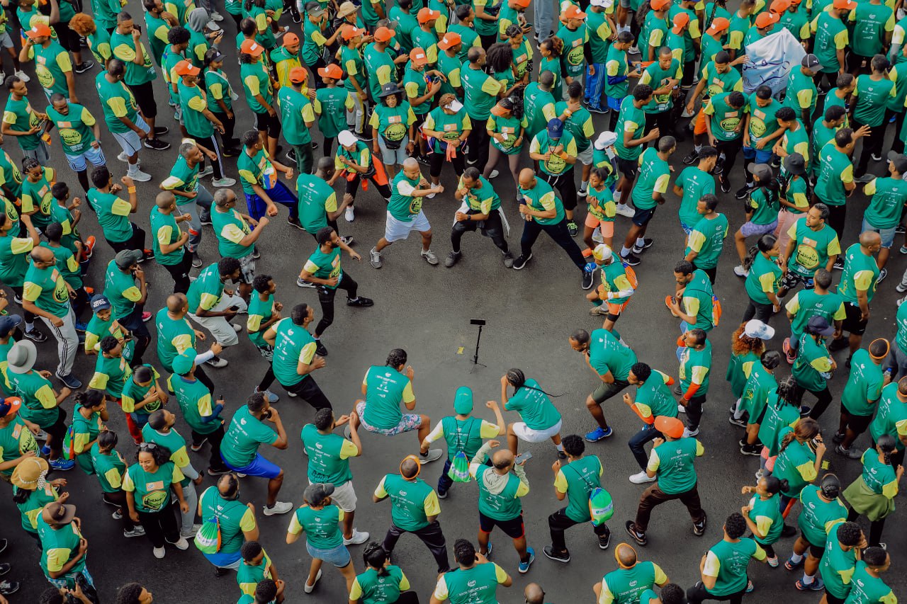 Crowd of people in green shirts preparing to run