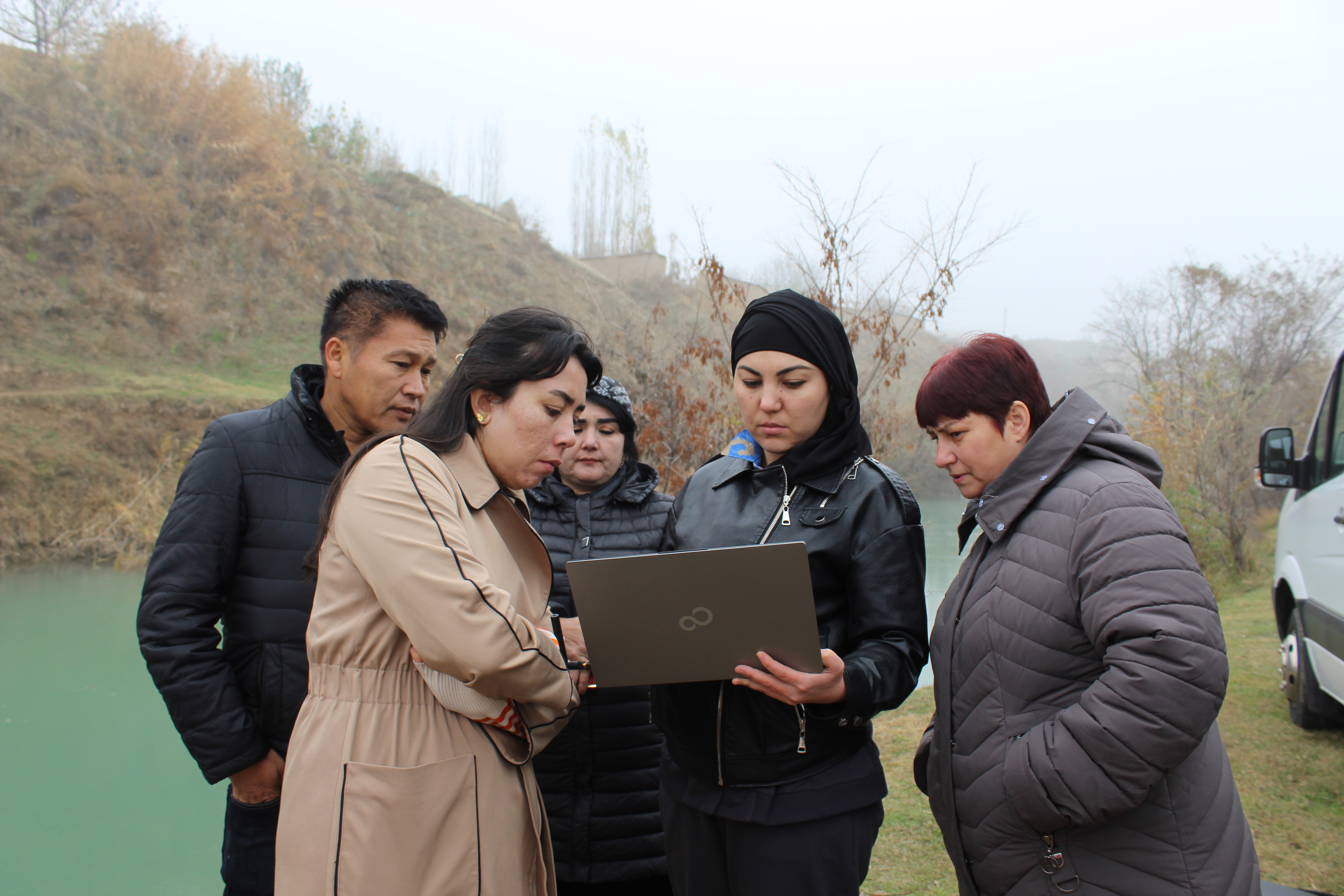 Training participants are learning on the spot - by the river