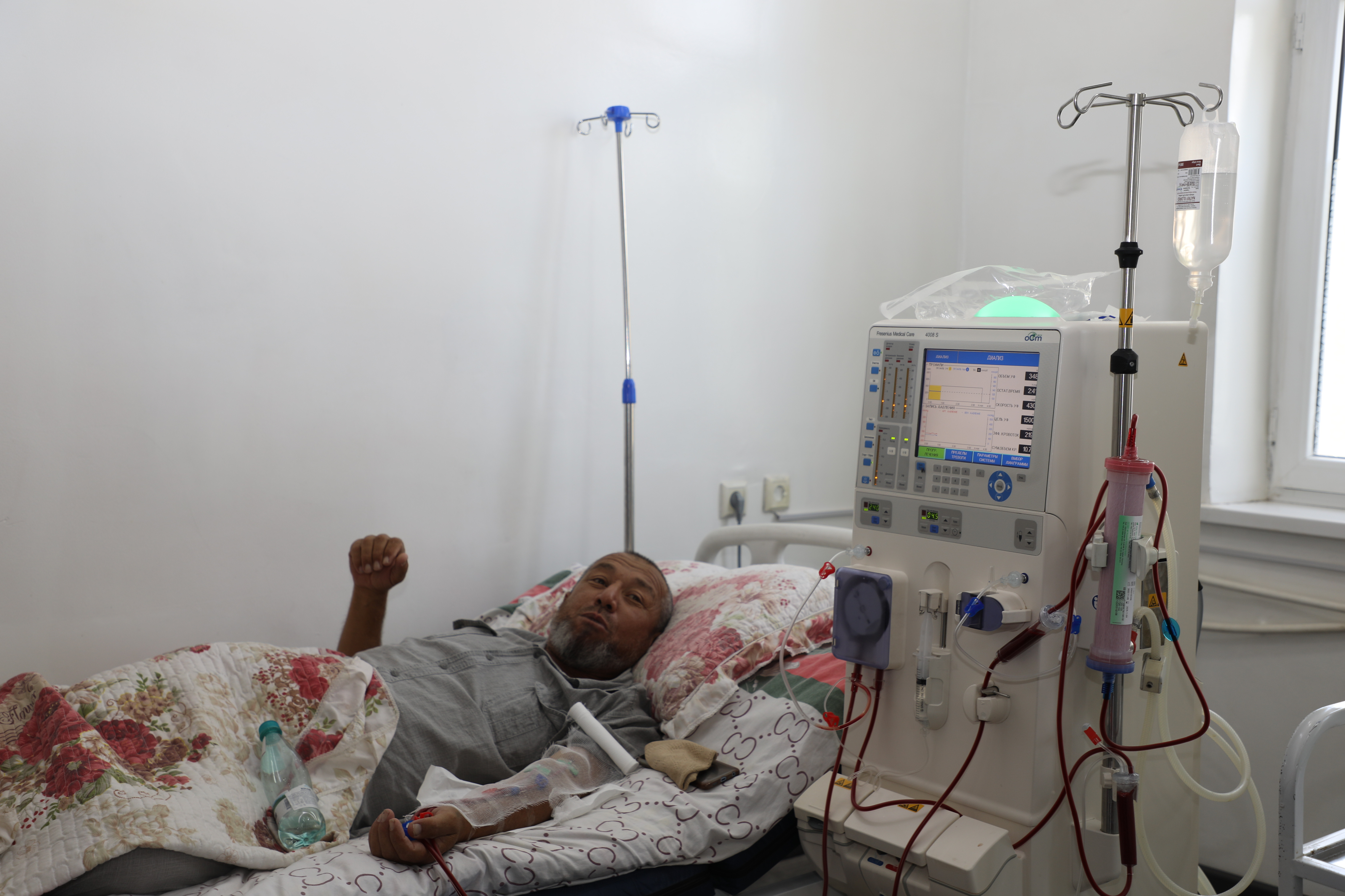 a man in hospital receiving hemodialysis treatment
