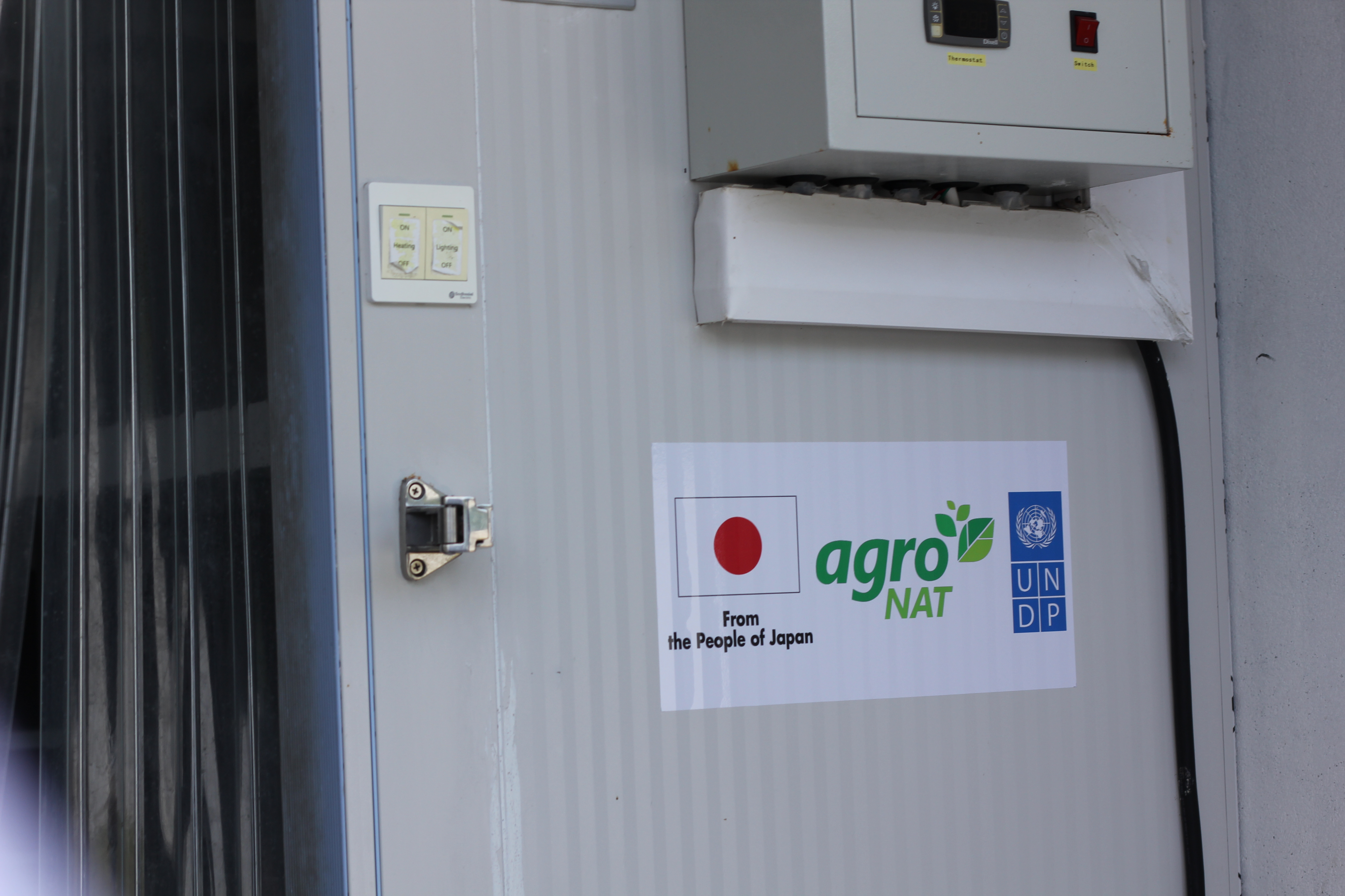 signboard outside cold storage with UNDP, Japan and Maldives agro company logos