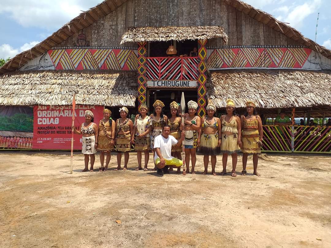 a group of people sitting on a bench in front of a building