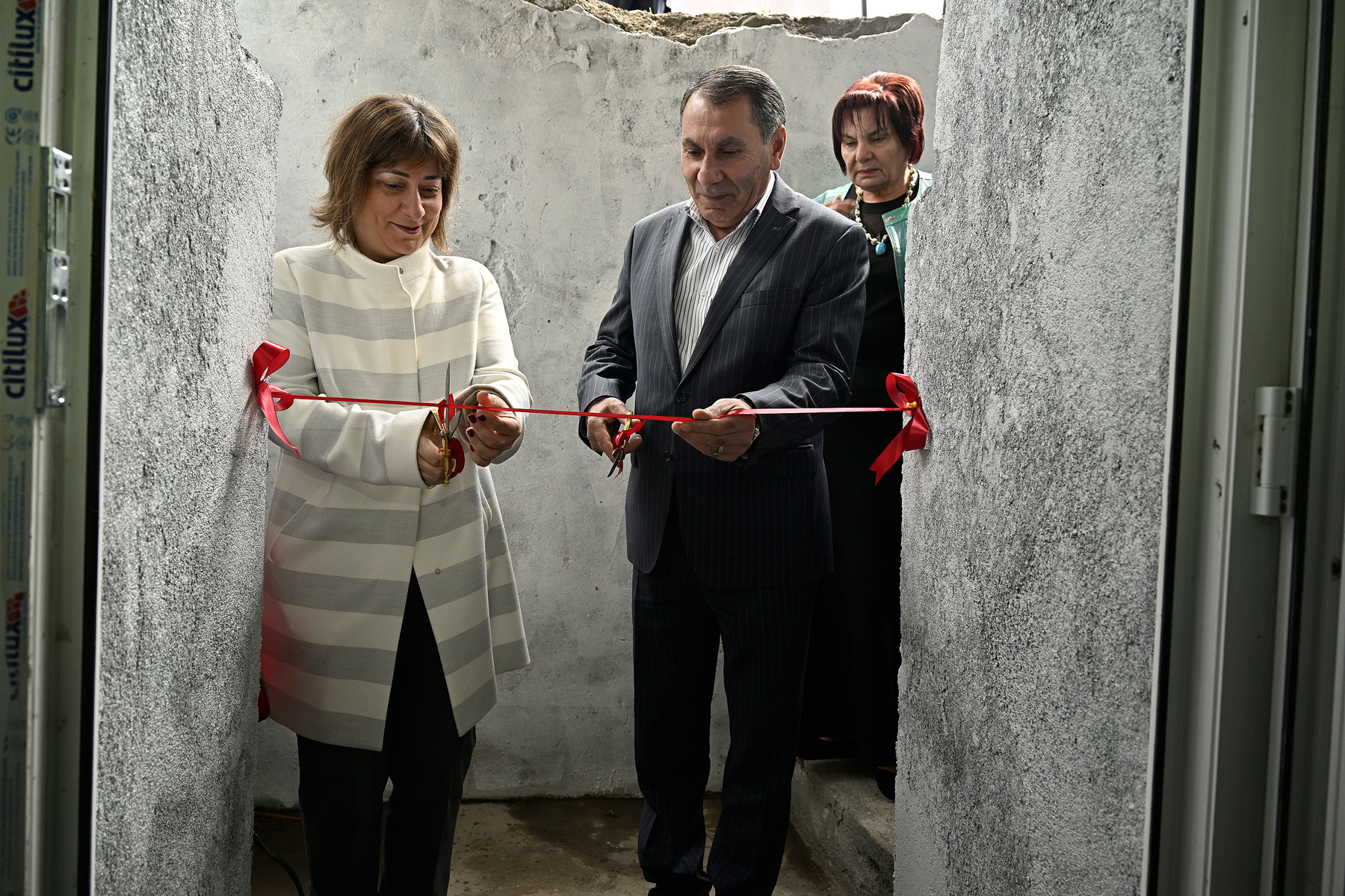a man and a woman standing in front of a door