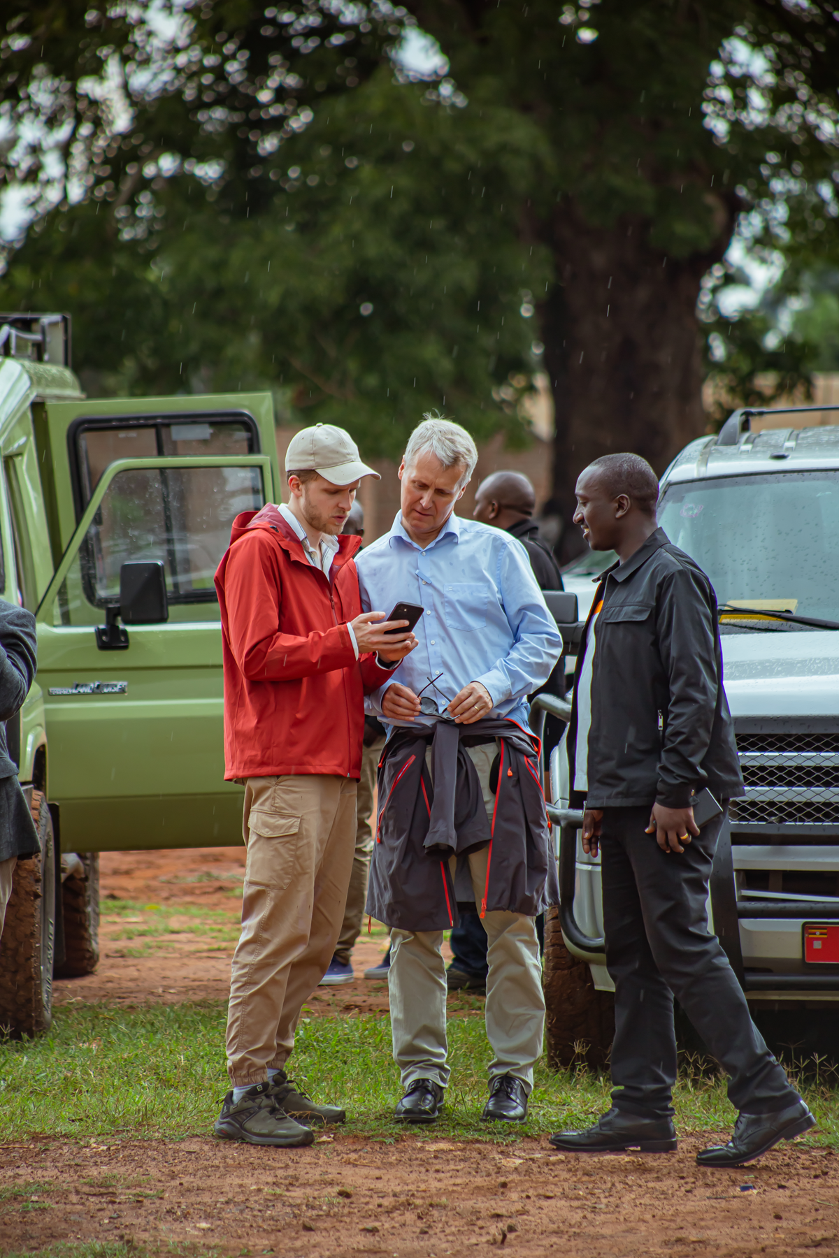 a group of people standing next to a car