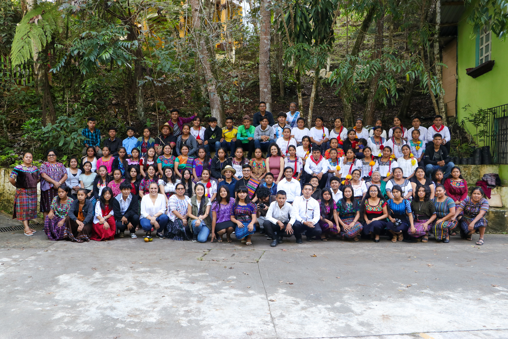 a group of people in front of a crowd posing for the camera