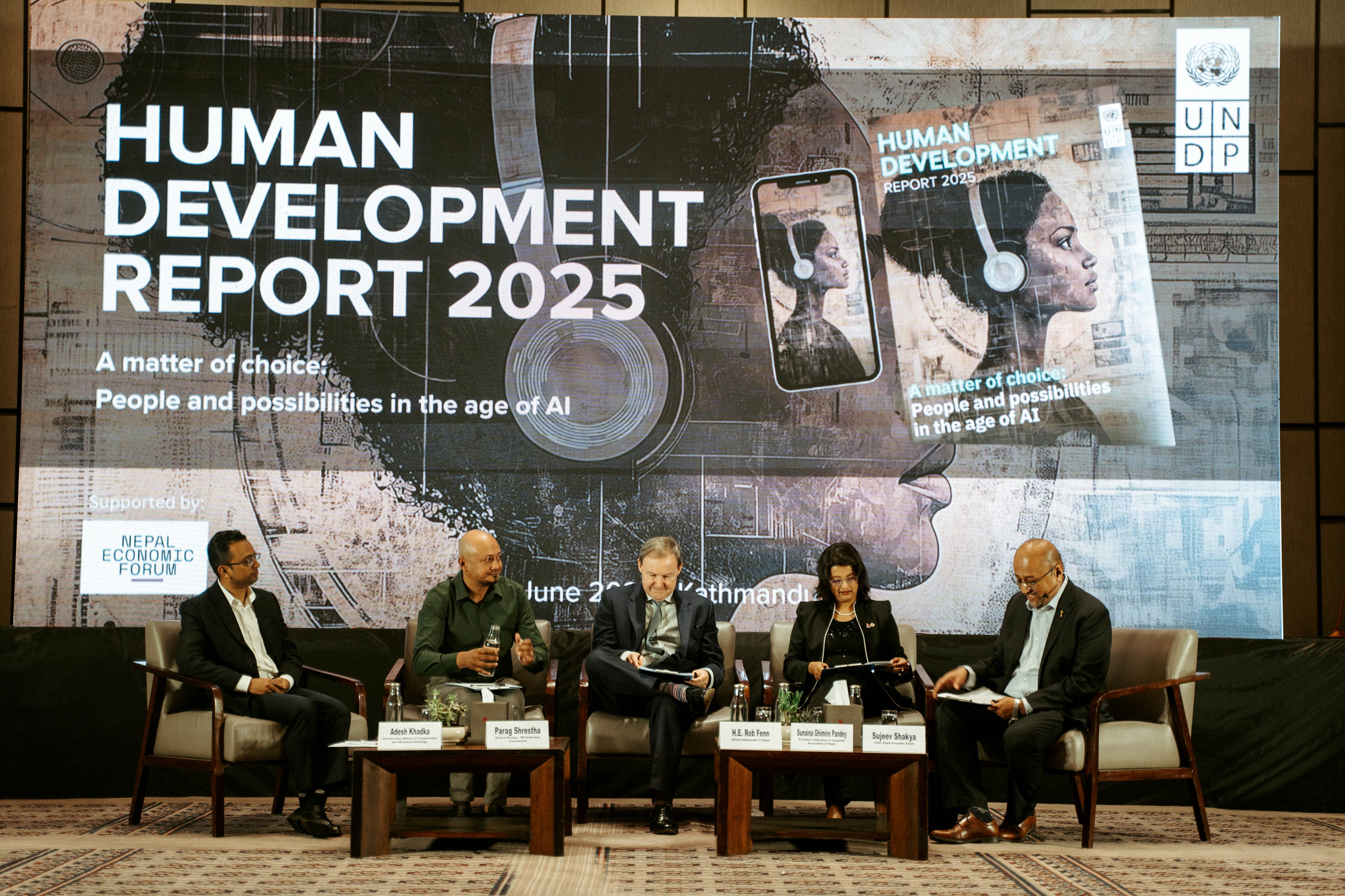Panel discussion on the Human Development Report 2025 with five speakers on stage.