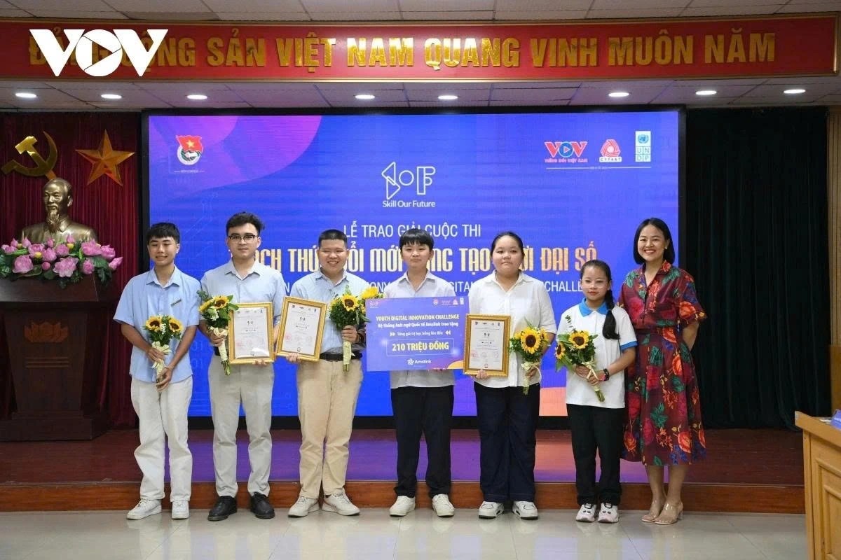 Group of students receiving awards, holding flowers, in a formal ceremony setting.