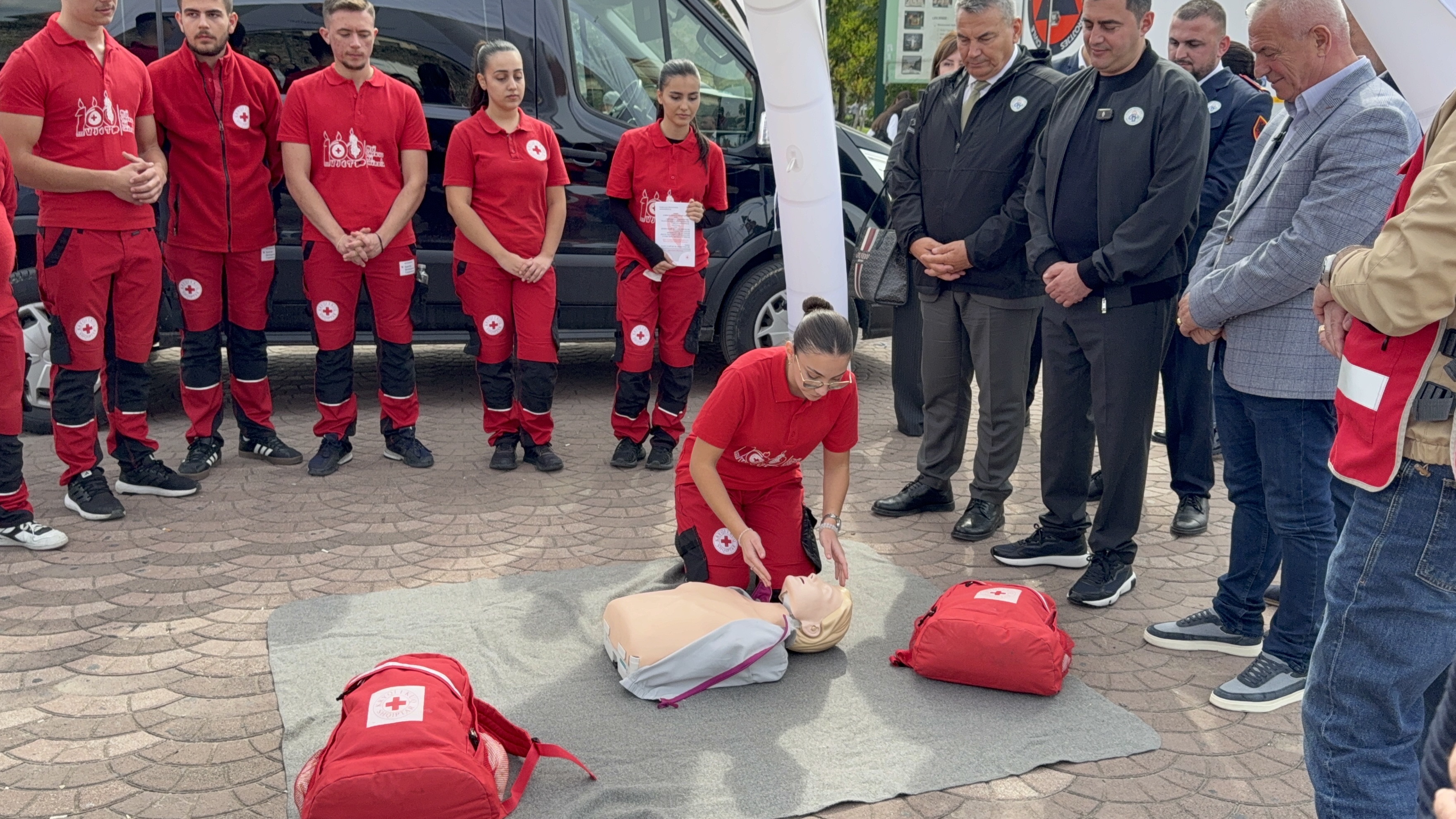 Jusra Zykollari explaining first-aid techniques and evacuation tips to students and families.