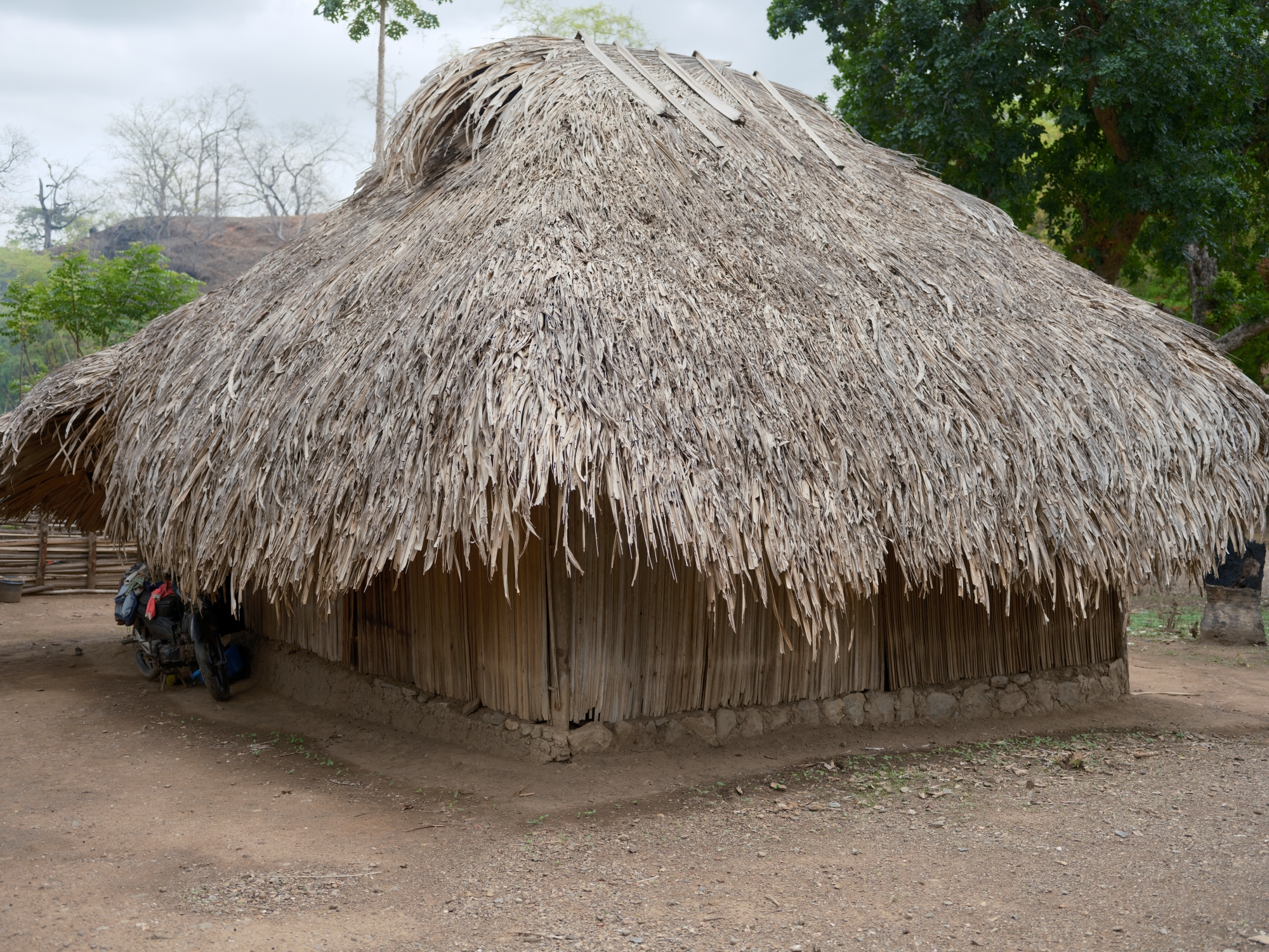 A traditional home in Uma Naruc, Manatuto, where families like Lucia Cabral's once retreated into darkness each evening, their activities constrained by the setting sun. | UNDP BRH/Kapil Das