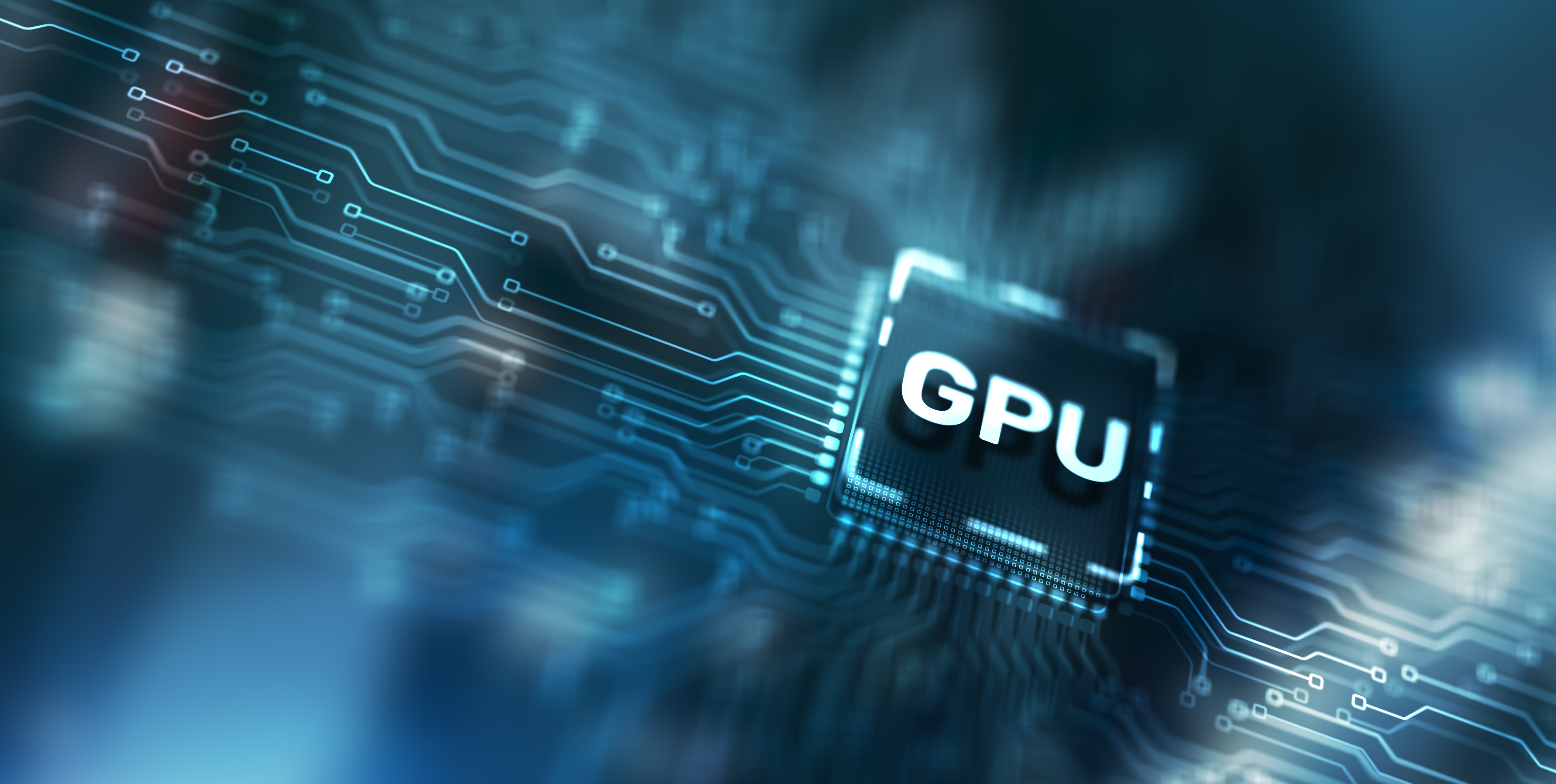 Close-up of blue circuit board with a glowing GPU chip. 