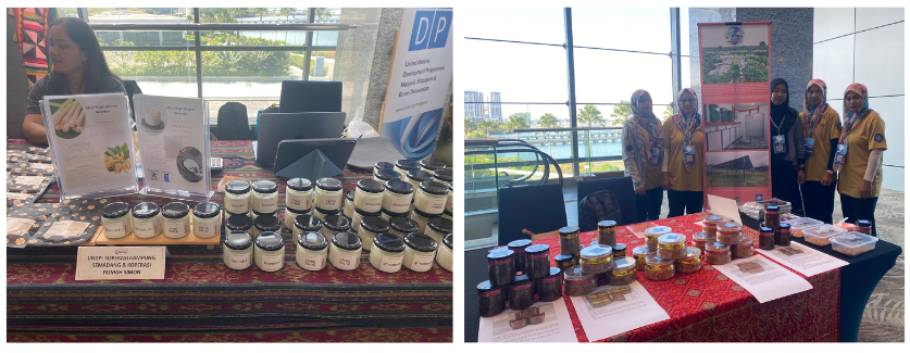 Two market stalls at a craft fair; left table with wooden crafts, right with jars and people.