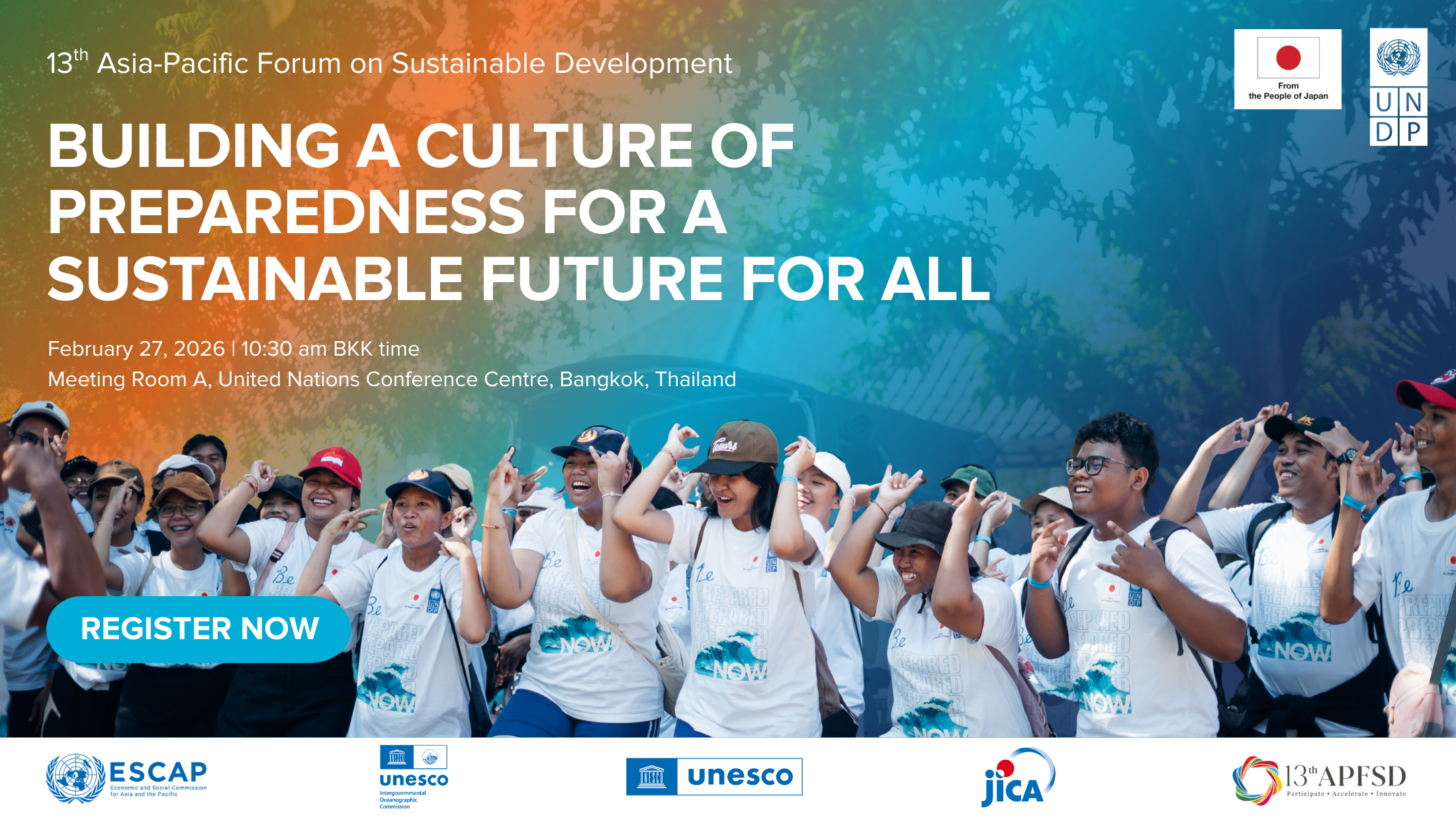 Photograph of people in white shirts raising hands at a conference; banner on a sustainable future.