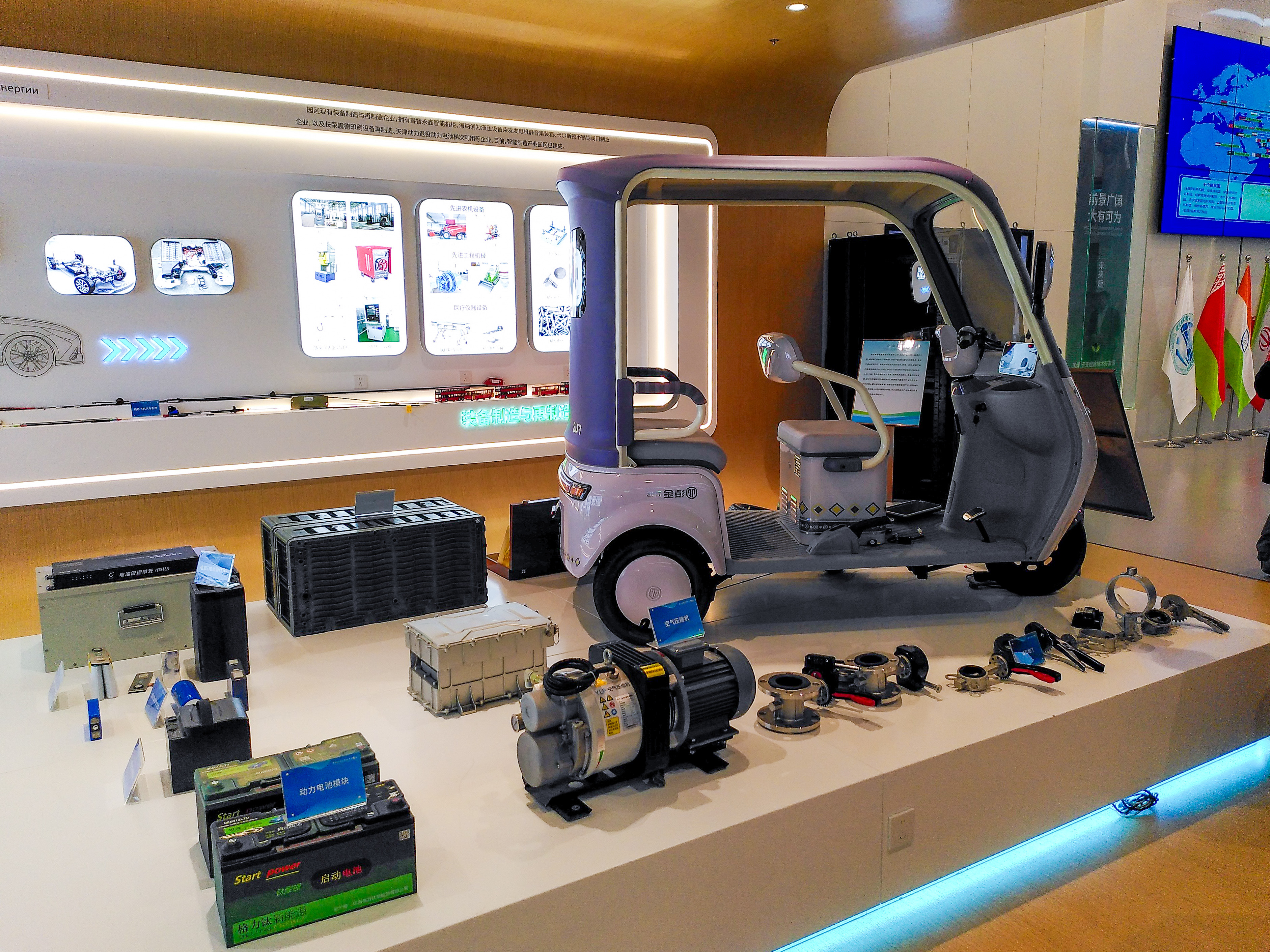 Display table of robotics toys in a store, featuring a purple vehicle and several small robots.