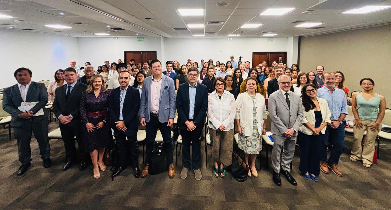 Group photo of professionals in a conference room.