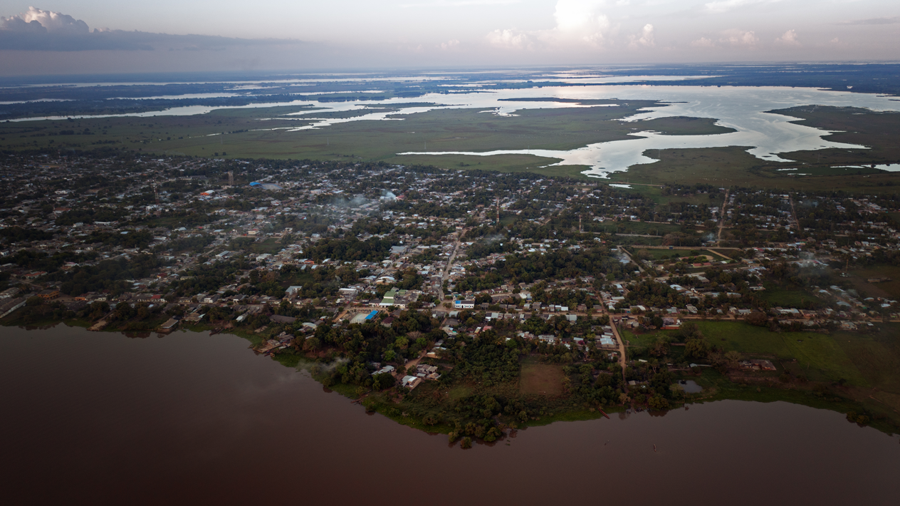 Aerial view of a coastal town with winding waterways and marshlands along the shore.