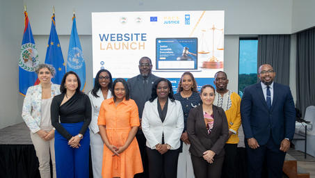Group of professionals posing at a website launch event; screen behind reads Website Launch.