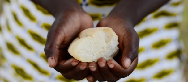 Hands of African woman holding wheat-based food ball
