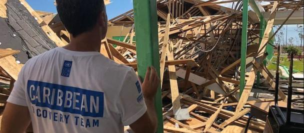 A UNDP recovery worker views damage from Hurricane Dorian.